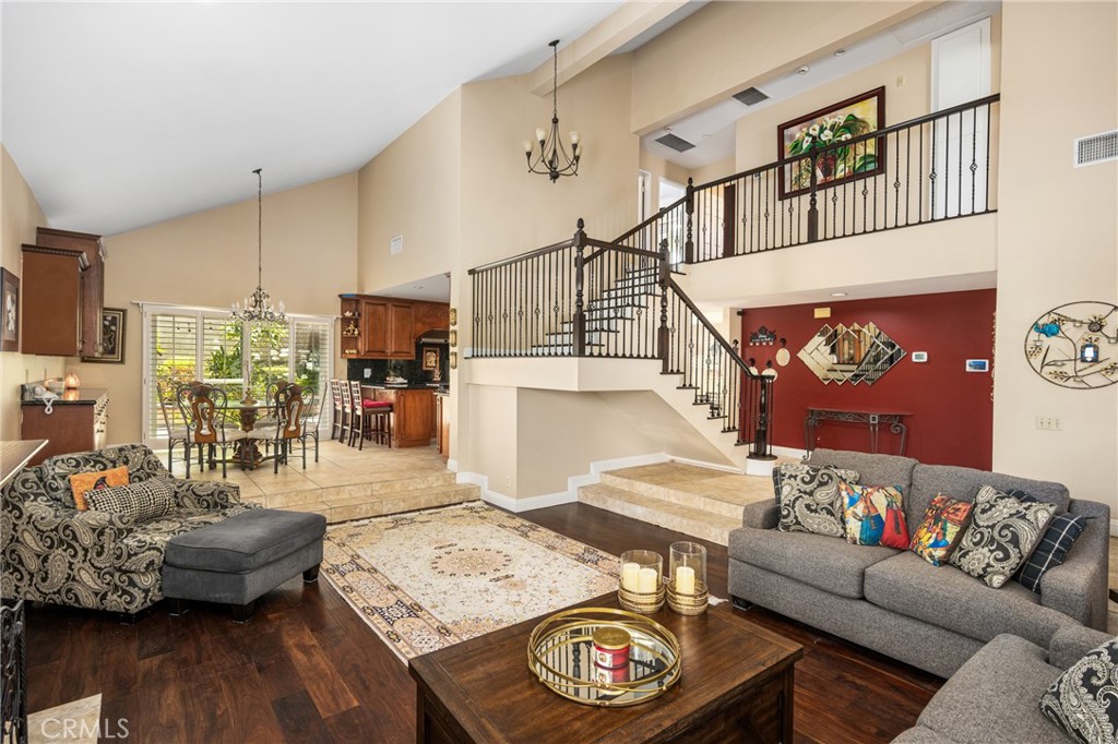 Beautiful 2 Story Home, Shows Pride of Ownership, Nice Front Porch Sitting Area, 3 Bedrooms, 2 Fully Remodeled Bathrooms (UPSTAIRS), and 1 Bathroom (DOWNSTAIRS), ***4th Bedroom Was Turned into the Primary Bedroom 2nd Walk-In Closet. It Can Be Converted to 4th Bedroom Again***, Dramatic Entry with Cathedral Ceiling in Formal Entry Hallway, Stained-Glass Door, and Beautiful Open Banister with Wood & Wrought Iron, Formal Living Room with High Ceilings and Gas Burning Fireplace, Dining Room with Built-In Cabinets and Large Sliding Glass Door, Huge Remodeled Kitchen with Newer Cabinets & Granite Counter Tops, All Stainless-Steel Appliances, Walk-In Pantry Closet, and Ample Counter Space, Enormous Sized Family Room With 2 Sliding Glass Doors, and Wet Bar For Your Entertainment, Approximately 2,563 Square Feet of Gracious Living Space, Primary Suite Has Two Huge Walk-In Closets with Built-In Organizers, Standing Shower, Dual Sinks, High Ceilings, Large Sliding Glass Door, and Balcony For Your Enjoyment, Window Shutters and Newer Vinyl Windows Throughout, Recessed Lighting, Mirrored Closet Doors, and Ceiling Fans, Dual Zone Heating & Cooling System, Water Softener, Upgraded Baseboards, Wood & Tile Floorings Throughout, Beautiful Backyard With Impressive Pavers, Large Covered Patio, and Fire Pit, 3 Car Side by Side Attached Garage with Direct Home Access, Rain Gutters, Association Pool, Spa, Tennis Court, and Club House, Approximately 7,700 Square Foot Lot, Minutes To Award Winning Schools, Nearby Parks, Golf Course, Hiking Trail, and Shopping