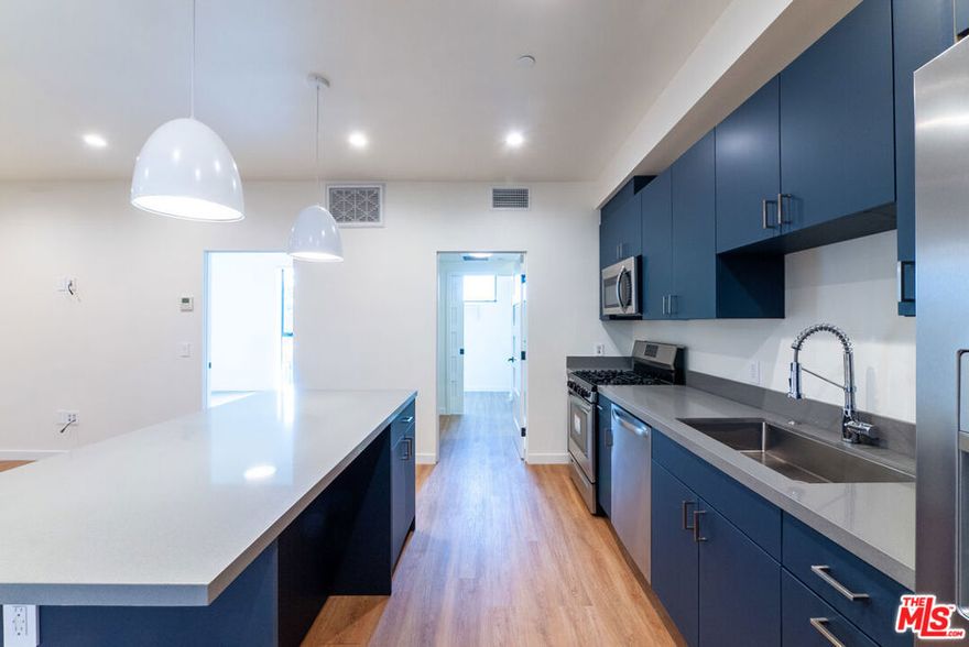 Enter into Apartment #3 and start the New Year in a space that actually feels like an upgrade.  This beautifully designed home features a show-stopping chef's kitchen with a center island, sleek finishes, and LED lighting throughout. Large windows bring in gorgeous natural light, while modern roller shades offer privacy when you want it. You'll also love the in-unit washer & dryer, and an impressively spacious walk-in closet that feels more like a personal dressing room than storage.Parking is easy and secure with gated, ground-level tandem parking yes, two dedicated spaces are included. Take the elevator up to the second floor, open your front door, and let the kitchen welcome you home. The living room offers plenty of space to unwind or entertain, and the bedroom comfortably fits a king-size bed. The bathroom is accessible from both the bedroom and main living area and features a sleek, glass walk-in shower for a spa-like finish.With just 8 total units, this boutique building delivers the perfect balance of privacy, quiet, and elevated living right in the heart of iconic Hollywood. Location-wise, it doesn't get better: easy access to the 101 and Santa Monica Blvd, close to top dining spots like Providence and Osteria La Buca, Larchmont Village favorites, and everyday conveniences including Paramount Studios, Pavilions Market, Smart & Final, and more.New year, new space, new energy.