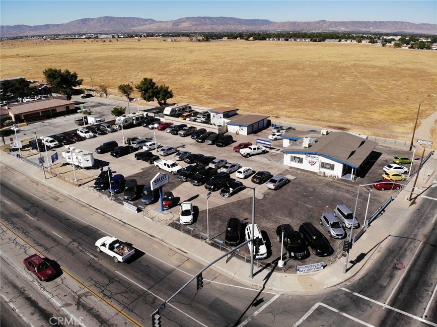With combined traffic counts exceeding 52,000 vehicles per day, this highly visible commercial property is situated at the signalized intersection of Sierra Highway and Avenue K.  The property is 0.86 acres and has two buildings.  The larger building is 2,684 square feet and the smaller building is 299 square feet.  There are two curb cuts, one on Avenue K and one on Sierra Highway.  This property is part of the acreage identified for the Parkway Specific Plan.  The "Valley Auto Center" property will be delivered vacant, except for one tire shop tenant.