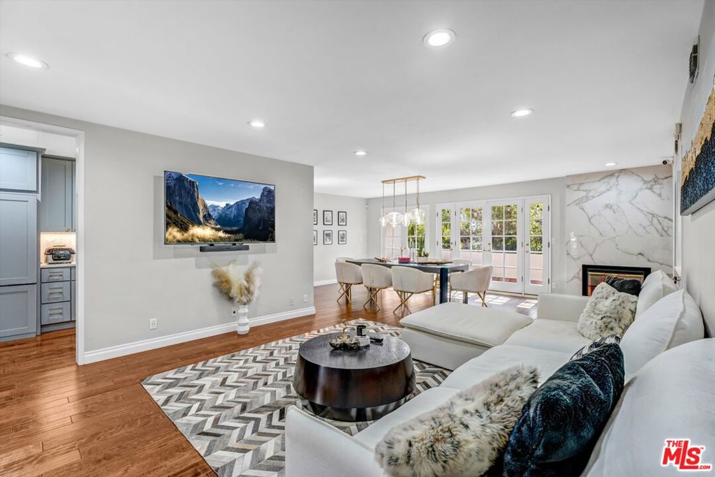Discover this charming condo on Darlington, nestled in an intimate 4-unit building in the heart of Brentwood. With no shared walls and an abundance of natural light, this residence offers the privacy and comfort of a single-family home. The open-concept layout showcases custom cabinetry, designer window treatments, a stylish wet bar, and a show-stopping kitchen with brass accents, pot filler, paneled appliances, marble chevron backsplash, and quartz countertops. Perfectly move-in ready, this home invites both lively gatherings and quiet evenings by the fireplace. Additional highlights include in-unit laundry, a private storage space, and a full-width balcony. A rare Brentwood find not to be missed!