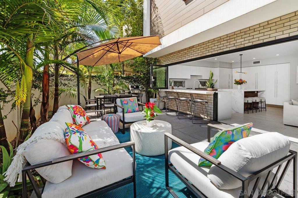 Experience the best of Coronado living in this stunning first-floor condo, completed in 2019. Designed for seamless indoor-outdoor living, this exquisite residence boasts a spacious 700 SF (approx) private patio that blends effortlessly with the interior through a wall of folding doors and windows. The open, single-level floor plan is thoughtfully designed for both comfort and convenience, making it ideal for seasonal getaways or full-time low-maintenance living. Every detail has been meticulously curated, from sleek designer finishes to top-of-the-line appliances, including a Sub-Zero refrigerator and a Wolf 6-burner gas range. The primary suite offers a peaceful retreat with a generous walk-in closet, dual-sink vanity, and private patio access. Additional features include a direct-access two-car garage with ample storage for cars, a golf cart, bikes, and more, plus a private in-unit laundry for added ease. Centrally located in the heart of Coronado, you’ll enjoy effortless access to parks, acclaimed restaurants, and the bay and beach—all just moments away. Don't miss this opportunity to embrace the ultimate coastal lifestyle in one of Coronado’s most sought-after locations!