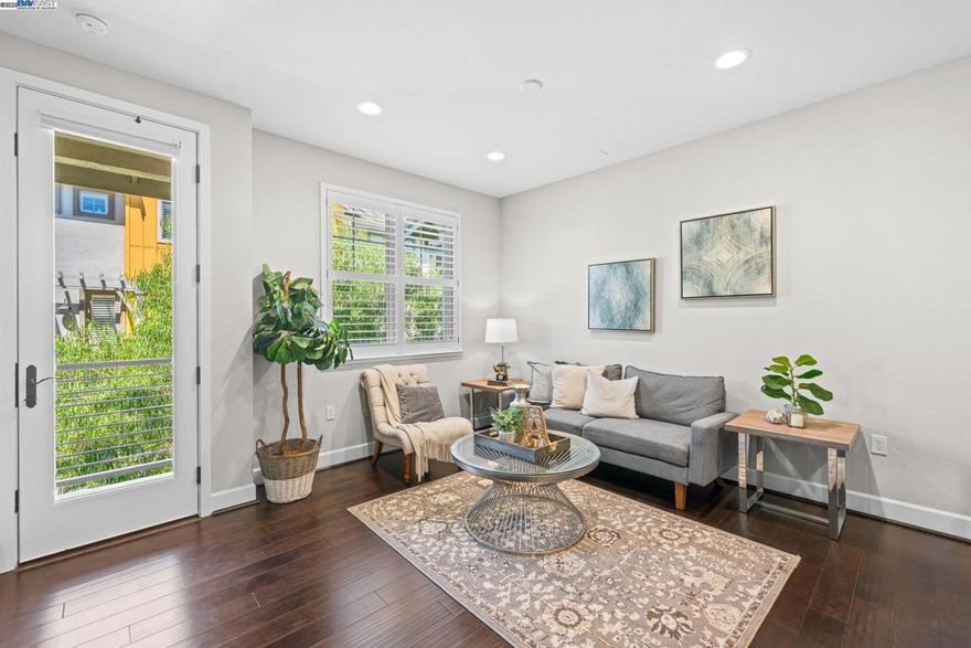 Tucked away in one of the most private and sought-after locations in the community, this stylish home offers peaceful views of the park and features 3 bedrooms and 3.5 bathrooms.  The entry level features a private bedroom, a full bath plus a dedicated laundry room and direct access to the oversized two-car garage with windows, complete with an EV charger. On the second floor, you will find an open concept great room with a sleek, upgraded kitchen featuring quartz countertops, a designer backsplash, GE Café appliances, breakfast bar seating, and modern lighting. The adjoining dining and living areas create a seamless space for entertaining or relaxing. Upstairs, two generously sized bedroom suites provide peaceful retreats. Designer touches throughout include laminate flooring, premium carpet, mirrored closets, built-in cabinetry, plantation shutters, and glass enclosed showers. Enjoy access to the community’s resort style amenities; pool, fitness center, clubhouse, park, picnic areas, and more! Conveniently located near I-580, Highway 84, BART, ACE Train, San Francisco Premium Outlets, and Livermore’s award-winning wineries.