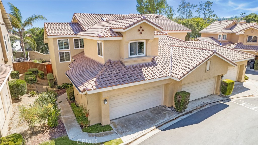 Located on a quiet interior location, this beautifully upgraded townhome features one of the largest and most private lots in the community. Tranquil views of the green belt with HOA-maintained trees behind, offers the perfect backdrop for relaxing or entertaining. The expansive outdoor space includes a covered patio with ceiling fan, built-in hardscape planters that double as seating and plenty of room for gardening or play. Inside, two-story ceilings and walls of windows flood the home with natural light. The open floorplan includes 2 bedrooms, and a generous loft is the perfect 3rd bedroom, office, or bonus space. The remodeled kitchen features white shaker cabinetry, recessed lighting, newer stainless-steel appliances including a 5-burner gas range, ample counter space and pantry pull-out drawers. The kitchen opens seamlessly to the inviting living room with fireplace and dining room with hardwood flooring that continues throughout the home. Upstairs you’ll find two spacious primary suites. One includes a remodeled bath with dual vanities, stone-surround soaking tub/shower, skylight, privacy door and two closets. The second offers high ceilings, a charming window seat and a private entry that feels like a hotel suite. The loft includes custom built-in desk, bookcase, and an entertainment center. Additional features of the home include new dual-pane windows, new HVAC and ducting, crown moulding throughout, upgraded baseboards, updated electrical, leaded glass windows, skylights, ceiling fans, PEX repipe, OWNED water softener, new bathroom hardware and fixtures, inside laundry with white shaker cabinetry and 2-car attached garage with insulated door and opener. The Scenic tract, surrounded by Tijeras Creek Golf Course, offers views of Saddleback Mountain, miles of hiking and biking trails, and resort-style amenities—community pool and spa, SAMLARC’s 4 pools, Beach Club at RSM Lake, clubhouse, tennis, pickleball, sport courts, splash park, fishing, and special events including the 4th of July Spectacular. Walking distance to award-winning, CA Distinguished Arroyo Vista K-8. No Mello Roos. Recognized as the #1 Safest City in California and #15 in the U.S.