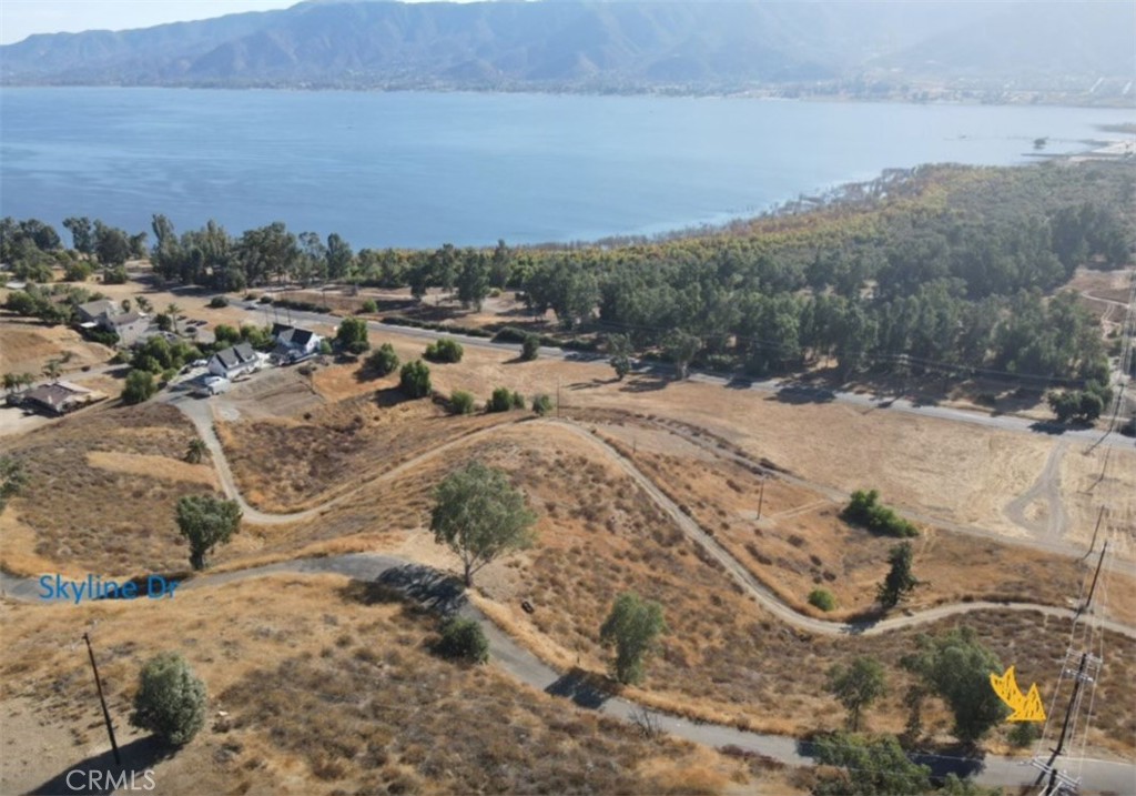 Newly Reduced! Beautiful land at a flashpoint pricing. Prime R2 Residential Lots with Lake and Skyline Views! Unlock the potential of these two adjacent lots in the desirable Lake Elsinore area, totaling 5,228 sqft. With convenient street access and essential utilities—water and electricity—available, this property is ready for your vision. Perfect if you want to buy for investment value or you want to purchase in addition to adjacent properties to combine to meet city building requirements Zoning: R2 Residential, perfect for multi-family or single-family homes, Breathtaking Views: Enjoy panoramic lake and skyline vistas from your future residence, Established Neighborhood: Many homes have already been built nearby, fostering a vibrant community, Convenient Amenities: Just under 3 miles from a variety of restaurants and markets, including Costco, Lowe's, LA Fitness, Chick-fil-A, and Golden Corral, ensuring all your shopping and lifestyle needs are met, Easy Access: Less than 3 miles from the I-15 Freeway for effortless commuting Centrally Located, Major Metropolitan Access: Centrally positioned, this property offers a quick commute to all major metropolitan areas—San Diego, Los Angeles, Orange County, San Bernardino, and Riverside—each within an hour and a half drive or less. Property Details: Location: Skyline Dr (No street number), Topography: Downward slope, ideal for creative building designs. This is a unique opportunity to invest in a beautiful piece of land with limitless possibilities! Whether you're planning to build a family home or an income-generating property, don’t let this chance slip away. Contact us today for more information! No sign. Property is directly across from the water containment system above and lies just below the utility pole on a downward slope.