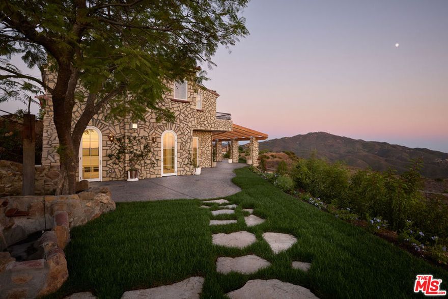 A Mediterranean inspired retreat created by Apel Design Studio, this Malibu estate spans 4.5 acres with sweeping whitewater views of the Pacific. Blending the timeless charm of an Italian countryside villa with the serenity of a private coastal sanctuary, it offers the perfect balance of seclusion and accessibility, just 15 minutes from Point Dume and the 101 Freeway. Every detail of this two story, 4 bedroom, 4 bathroom residence has been crafted as a work of art. With approximately 4,565 square feet including the garage and 3,100 square feet of covered and uncovered patios, the home is designed for both indoor and outdoor living. Intricate mosaic installations, hand carved exterior fountains, copper shelving, custom vanities, sculptural light fixtures, and original works throughout reflect the artistry and vision of Apel Design Studio, all composed with natural, locally sourced materials. Signature spaces known as the Sunset Room, Sunrise Room, and Horizon Room frame Malibu's daily magic of ocean sunrises and glowing sunsets. Expansive flat areas create endless opportunities for gardens, gatherings, or even a self sustaining lifestyle in a serene countryside setting by the sea. Surrounded by lush vineyards, orchards, and greenery, the property offers countless places to lounge, reflect, and recharge. Private, inspiring, and truly one of a kind, this estate is more than a residence. It is an invitation to "Connect to the Art of Living. "