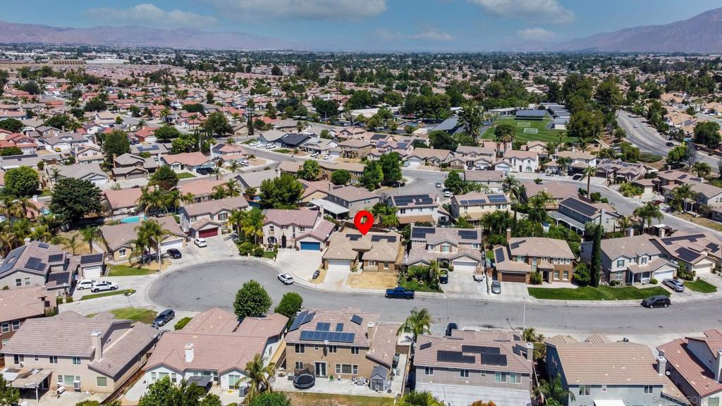 Discover the potential of this spacious single-level home in the desirable Rancho neighborhood of San Jacinto. Nestled on a quiet cul-de-sac, this residence offers living space and a generous lot size, perfect for those seeking comfort and room to grow. Step inside to an open floor plan with a bright kitchen featuring ample cabinetry, a center island, and sliding glass doors leading to the backyard. The adjacent family room is warm and inviting with a fireplace and large windows for natural light. A separate living area offers flexibility for entertaining or relaxing. The spacious primary suite includes a walk-in closet and an en-suite bathroom with dual sinks. Three additional bedrooms and a full bath provide plenty of space for family or guests. Outside, enjoy a covered patio and a large backyard, ideal for gatherings, gardening, or adding your personal touch. The property also includes a two-car garage and a wide driveway for extra parking. Conveniently located near parks, schools, shopping, and dining with easy access to major highways—this home combines a great location with incredible potential. Bring your vision and make this charming home your own!