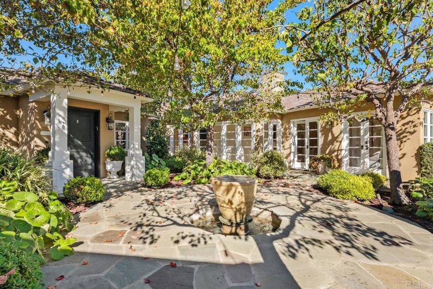 Ideally located on one of the most sought-after streets in the renowned Rancho Santa Fe Covenant, this enchanting single-level home seamlessly combines charm, sophistication, and functionality. Your private oasis awaits with an expansive backyard that borders acres of open space, impeccably groomed trails, and just a short walk to the Rancho Santa Fe Village, the acclaimed Roger Rowe Elementary and Middle schools and the Rancho Santa Fe Golf and Tennis clubs. You will immediately fall in love with the beauty of the lush landscape and the inviting private courtyard entry. The home boasts a freshly remodeled kitchen, and exquisite reclaimed maple floors throughout. It has a sun-drenched great room, and a gourmet eat-in kitchen, that seamlessly open onto the pool and entertaining areas with westerly views and gentle ocean breezes. The interior design includes 5 bedrooms, 4.5 baths and floor-to-ceiling windows and French doors that seamlessly caters to the indoor/outdoor living you can enjoy year-round in San Diego.