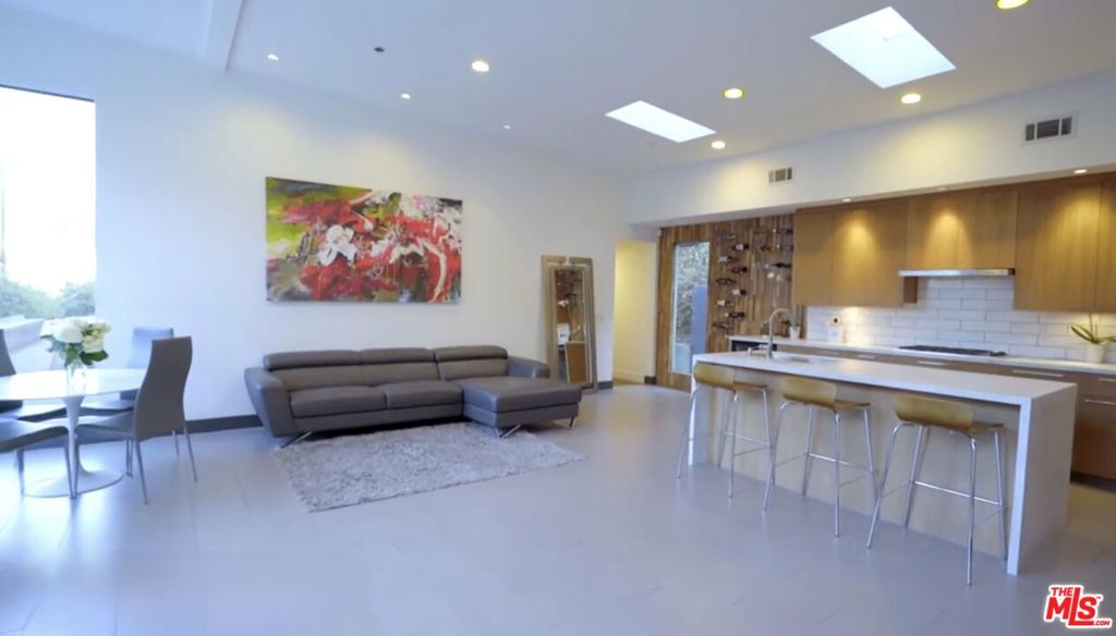 Single-Level Modern Home with Open Concept Living. Prime Location, available furnished or unfurnished. This beautifully designed single-level residence exudes modern elegance, featuring sleek lines and expansive windows that invite natural light throughout. The thoughtfully crafted open floor plan flows seamlessly from a spacious living area to a designer kitchen, complete with exquisite Carrara marble countertops, top-of-the-line stainless steel appliances, and a generous island perfect for hosting gatherings. Enjoy the serene ambiance as you take in views of lush greenery from the house and the deck, creating a relaxing atmosphere that invites you to unwind and connect with nature. Retreat to your luxurious primary suite, boasting a spa-like bathroom with a walk-in shower and a custom closet designed for ultimate convenience. An additional room offers versatile space for guests, or a home office. This home is located just minutes from Valley View Elementary School, short distance from iconic attractions like the Hollywood Bowl, Universal Studios, and world-class dining and entertainment.