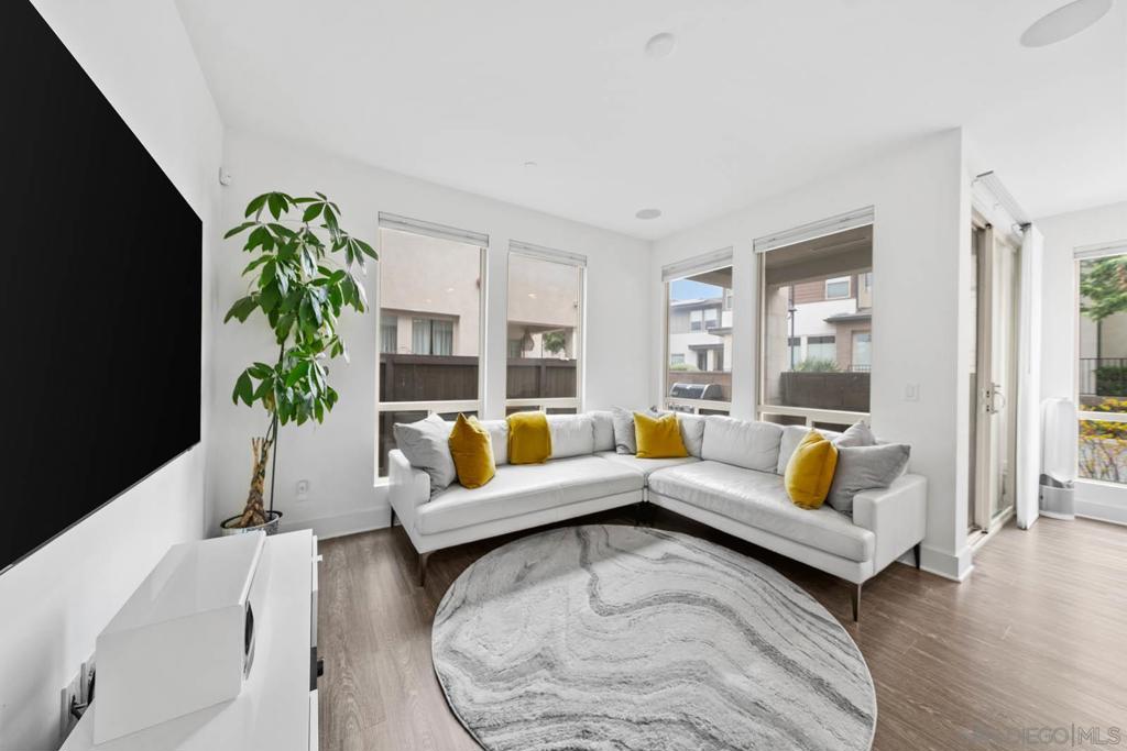 This upgraded 3 bed + loft, 2.5 bath Frame & Focus townhome delivers modern design and a prime location near a 14.3-acre park, Downtown, North Park, Kensington, Convoy District, and just minutes away from San Diego’s top schools, shopping, and beaches—this is the future of urban living. Step inside to find flat-finish walls, south-facing windows with abundant natural light, and an open layout anchored by a staircase with metal cable balusters. The chef’s kitchen features a spacious island, quartz counters and stainless appliances. For the larger rooms, the sunny primary suite offers a private balcony, walk-in closet, while the third-story loft adds flexible space for an office, gym, or lounge. The other two rooms are wonderful for kids and guests alike. Smart upgrades include dedicated EV charging, built-in wall speakers and AV routing for seamless digital entertainment, upgraded flooring, and an epoxy-coated two car attached garage. Additionally, a whole-home softening system and added water RO system downstairs ensures better water for drinking, bathing, and appliances. The fenced yard adds space for pets or grilling. Your HOA delivers unmatched value with a gym, resort-style recreation center with adult + kids’ pools, hosting space for large groups and access to a community garden. Schedule a tour today!