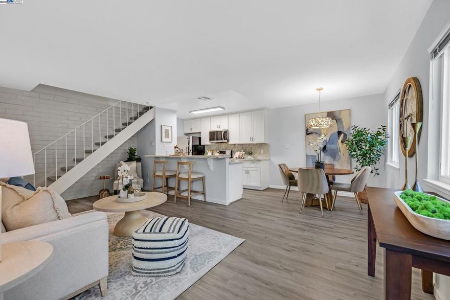 Shows just like a model. Lovely renovated sun filled corner unit. The updated kitchen has stone counters with SS appliances and an open concept kitchen family room combination with breakfast bar. New paint  throughout and new flooring upstairs. Nestled in a court location and surrounded by multi-million dollar neighborhoods. Enjoy excellent schools and easy access to 680/580 freeways, Ace train and Bart. One covered carport and one extra parking space behind the carport. Two closets in the carport area for storage. Amenities include swimming pool, playground and picnic area. Hoa fees includes water, sewer and garbage. No rental restrictions. Welcome Home!