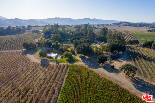 149+acre working Family/Friend Ranch compound is ideal for the those seeking a peaceful lifestyle for sustainability and diversity. This unique property has been lovingly stewarded by the current owners for 3 generations and offers so much opportunity. Improve and expand the current 28+ ac vineyard, update the equestrian facility or grow new crops. Tranquility and beauty surround the original ranch home built in 1948 and the 1923 farm cottage with a large old barn +2 insulated warehouses (3200 & 4000sf) nearby. The equestrian facility sits across Refugio Rd. & includes a covered dressage arena, 14 stall horse barn, with apartments, paddocks, pens, and a 2bd home (8 residences in total on property!!) New ag well plus district water for ag and domestic use. Ag Preserve Tax benefit.