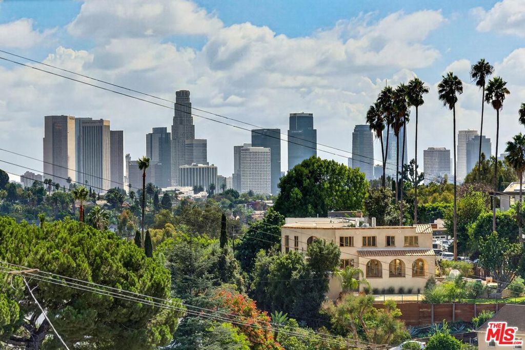 Stunning 2-Story Townhouse with Panoramic City Views in Silverlake. Experience modern living in this bright and spacious 2-story townhouse, perfectly positioned in a newly updated 6-unit building. Revel in breathtaking panoramic views that stretch from downtown Los Angeles to Century City, with spectacular sunsets that light up the skyline. Features include: Outdoor Spaces: Two sunny balconies with stunning views and a large private patio with a separate entrance. Interior Design: Rich, dark hardwood floors, soaring high ceilings, and abundant natural light. Modern Amenities: Stainless steel kitchen with a brand-new fridge, oven, and stove; in-unit washer/dryer; A/C; and a Nest thermostat for comfort and convenience. Parking & Security: Gated entry with intercom system and secure parking featuring two side-by-side spaces. Located in a peaceful, hilly neighborhood, this home offers a serene retreat while being within walking distance of Silverlake's best bars, cafes, shops, and restaurants. Enjoy the nearby Silverlake Reservoir and park for outdoor activities. With quick access to the I-5, 101, and 2 freeways, this central yet quiet location is ideal for urban convenience and tranquil living. Small, Friendly Community: The complex is intimate, quiet, and neighborly, making it a welcoming place to call home. Don't miss this rare opportunity to enjoy the best of Silverlake living!