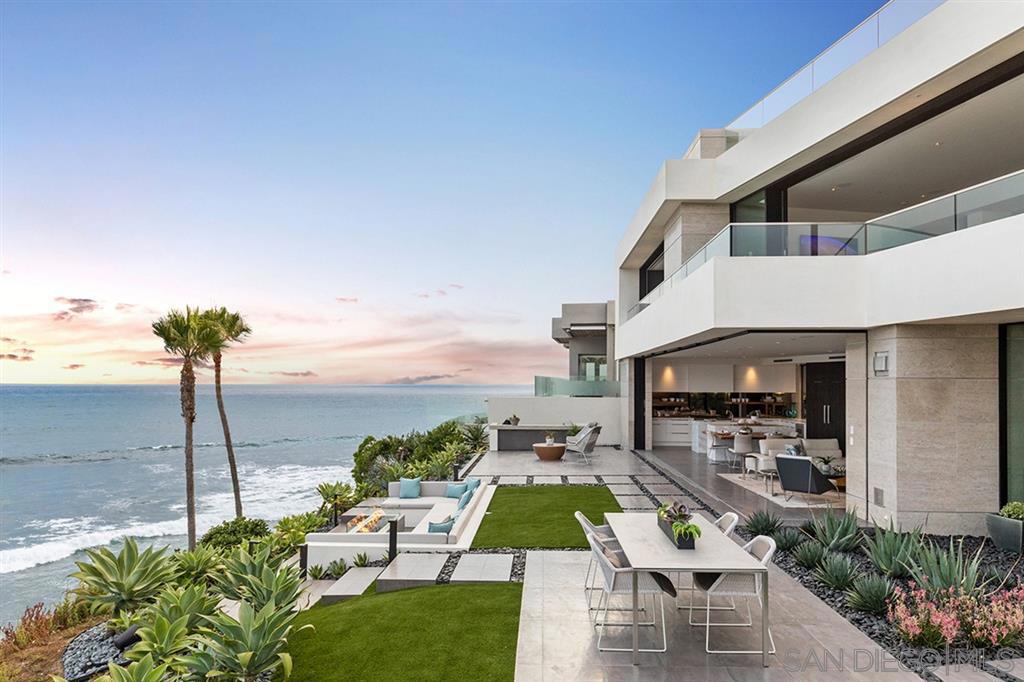 Incomparable ocean views seamlessly integrate with a NEW contemporary masterpiece. La Jolla’s Bird Rock Waterfront is now home to an awe-inspiring Blue Heron property that stirs emotions in ways you’ve never experienced. Perfectly sited and designed to capture unmatched southern and western views, the home offers a floating bridge, cascading water walls, glass foyer, and automated doors that perfectly blend & connect more than 3,000 SF of outdoor living spaces with a world-class, fully-furnished interior. Blue Heron, a nationally recognized and award-winning visionary and experiential firm, has designed and developed its first unmatched custom home in La Jolla. The more than 6,800 SF contemporary and sustainable home provides a unique setting with a view looking south to Crystal Pier, Point Loma, and the Coronado Islands and west to the sunset. 3eleven provides an unmatched modern living experience with a design that has maximized utilization of the lot and vertical space. The home is moved to the side of the lot to offer a long-entry experience over a floating bridge that pulls you toward the ocean view, led by fire and a lap pool spilling down two water walls into multiple vertical voids over the lower living area and entering an all glass foyer where the beach pebbles flow inside to dissolve indoor/outdoor boundaries. The master suite has been purposely laid out wide to maximize the sublime views with glass at the vanity and beyond the bed wall to allow for ocean views from every angle- from the bathroom to the oversized master closet and outdoor shower. A roof top entertainment space boasts magnificent 270-degree ocean views with a spa, adjacent bar, outdoor cooking, and a covered space shaded by a trellis of solar panels with strategically placed outdoor TVs. Other intentional spaces include three additional bedrooms and baths, two powder rooms, and media, wine and game rooms. An elevator and three-story stairwell provide access to multiple levels of contem...