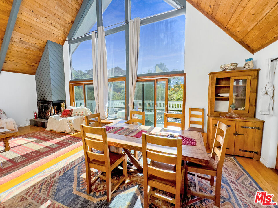 Available short-term, long-term, also For Sale Nestled in the heart of Topanga, this spectacular 5-bedroom, 3-bathroom A-frame home is a true gem. Ideally suited for families, especially those with school-age children, this home offers unmatched convenience. A private gate leads directly to Topanga School Road for Topanga Elementary, and the bus stop for Paul Revere Middle School is just a short stroll away, making daily routines a breeze for parents. The home's striking design bathes in natural light, with expansive picture windows in the living room offering views of the stunning canyon. The top-level loft master suite is an oasis of tranquility, featuring a private bathroom and a cozy office/library that invites you to unwind while taking in the sweeping views. The private patio off the master bedroom adds another layer of luxury, perfect for morning coffee or evening relaxation.The main level seamlessly blends country living with comfort, offering two spacious bedrooms, an open-concept kitchen, and a grand living room centered around a charming wood-burning fireplace. The full bath on this floor provides added convenience for family and guests.Outside, the wrap-around decks create an ideal setting for relaxation and entertaining, offering an exceptional space to soak in the beauty of the surroundings. The lower level features two additional bedrooms, a bathroom, and a guest kitchen, making it perfect for older children, in-laws, or visitors who appreciate their privacy. The converted garage adds even more flexibility, serving as a studio, gym, or home office. The perfect setting on a large, usable lot, with a fully fenced yard perfect for pets and play. Located just steps from Topanga's vibrant shops, restaurants, and nightlife, and only 10 minutes from Topanga Beach, this home offers the perfect blend of serenity and convenience. Recent updates, including a new roof, refrigerator, cooktop, water heater, and fresh paint, ensure that this home is move-in ready. Experience the best of Topanga living in this extraordinary home at the center of it all.