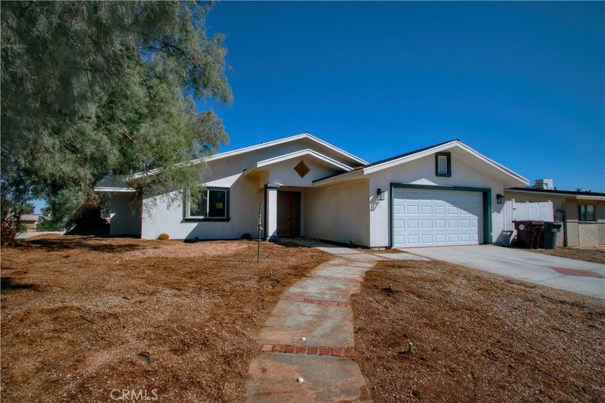 This large 4-bedroom, 3.5-bath home is full of potential with over 2,400 sq ft of comfortable living space in the heart of 29 Palms. Built in 2008, this home features a large open-concept great room, perfect for entertaining, and a modern open kitchen ideal for family gatherings or quiet nights at home. Enjoy the two primary bedrooms, each with its own private ensuite bath—ideal for multi-generational living or guest accommodations. The spacious interior includes a large indoor laundry room, natural gas heating, central A/C, and an energy-efficient tankless water heater. Additional features include an attached garage for secure parking and storage, and a generously sized layout that offers both space and functionality. Conveniently located near schools, shopping, and just a short drive to the 29 Palms Marine Base and Joshua Tree National Park, this home is perfect for military families, outdoor enthusiasts, or anyone seeking room to spread out in a great location. Don’t miss this rare find in 29 Palms – space, comfort, and convenience all in one!