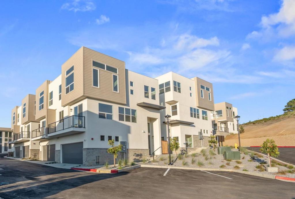 MOVE IN READY!!! $10,000 OF CLOSING COSTS CREDITS / INTEREST RATE BUYDOWN OFFERED TO BUYERS IF IN CONTRACT BY 9/30!!! Welcome to Pacifica Heights - Where Luxury meets Serenity! Each residence has been meticulously designed with modern architecture, spacious layouts, and energy-efficient features, ensuring a comfortable and environmentally responsible lifestyle. 807 Fassler: Highlighted by an open kitchen with large island and pantry area. The kitchen opens and flows seamlessly into the great room, providing flexibility to arrange your living and dining areas. An additional powder room on the main level is perfect for guests. Balcony area off of the living / dining area to soak in the majestic views. Luxurious primary bedroom with sliding door to a balcony and en-suite bath with a large walk-in closet. Primary bathroom featuring double vanities, freestanding tub, and separate shower. Additional features include in-unit laundry and attached two car garage. Prepare to be captivated by the awe-inspiring beauty of the Pacific Coastline. Residents at Pacifica Heights are treated to breathtaking ocean and canyon views. You'll wake up to the serenity of the coast and spend evenings on your private patio, savoring the coastal breeze. This is now Pacifica's finest address!