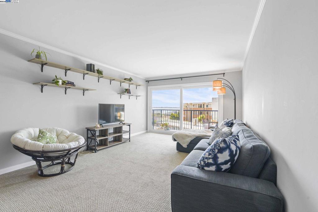 Prime top-floor end-unit with rare bay views at South Shore Beach & Tennis Condos. Arguably the best location in the complex, this stylishly updated 2BD, 2BA home features a bright, open layout with white Shaker cabinetry, soft grey walls, playfully painted bedrooms and sand-toned tile and carpet for an elegant coastal vibe. Take in sweeping, ever-changing bay views from the living room, primary bedroom, and southeast-facing balcony. The kitchen, dining, and living areas flow seamlessly, while both bedrooms offer generous closets, including a walk-in off the primary bath. Additional perks include a sparkling community pool, a clubhouse, greenbelts, community laundry, one garage parking space, bike storage, gated access and large shared interior storage rooms. Ideally located just minutes to public transit and the Alameda Ferry, and mere steps from Crown Memorial Beach with miles of scenic biking and jogging trails.