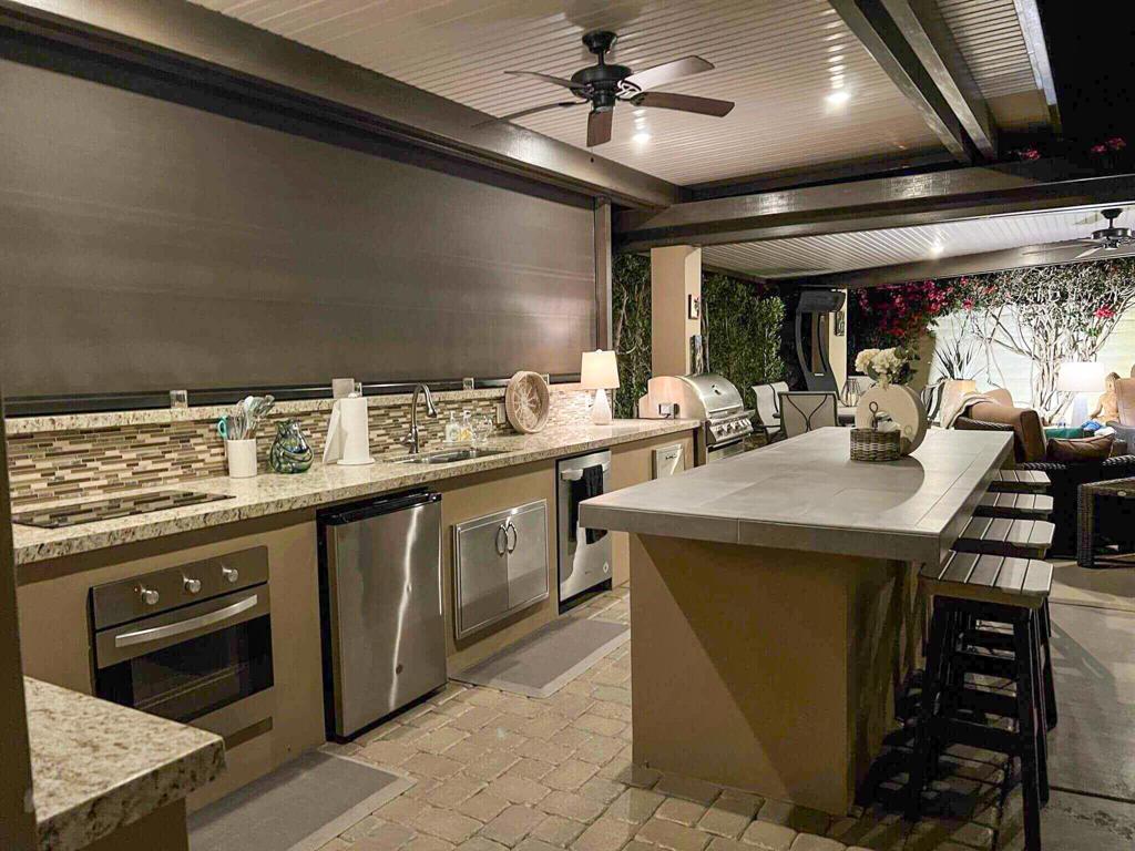 Nestled in the heart of Outdoor Resort Indio, a vibrant and friendly community, this luxury RV lot offers a peaceful retreat with unparalleled privacy and a low-maintenance, beautifully landscaped outdoor living space. Just a short walk from the main clubhouse and satellite pool, this prime location combines tranquility with easy access to the resort's world-class amenities.Designed for ultimate comfort and entertainment, the lot features a solid-roof Alumawood pergola with two custom power wind/sun/privacy screens, creating a shaded, comfortable space in any weather. The gourmet outdoor kitchen boasts granite countertops, a convection oven, induction cooktop, under-counter fridge, stainless steel sink, garbage disposal, dishwasher, and ample stainless steel storage. A 10-ft island with seating for four and a Blaze high-end stainless steel 4-burner BBQ with rotisserie (new in 2022) makes outdoor dining effortless. The expansive patio is fully furnished with a dining table for six, a 6-piece semi-circular seating arrangement with two recliners, a 36' Cilindro Pewter fire pit, and a matching propane tank enclosure, perfect for cozy evenings under the stars. A Bromic Tungsten freestanding portable heater, TV cabinet with a 65' TV, three storage containers, a 10-ft portable privacy screen, and an area rug complete this fully finished desert oasis, ready for you to enjoy resort-style living at its finest.ORI is a gated RV resort for class A motorcoaches.
