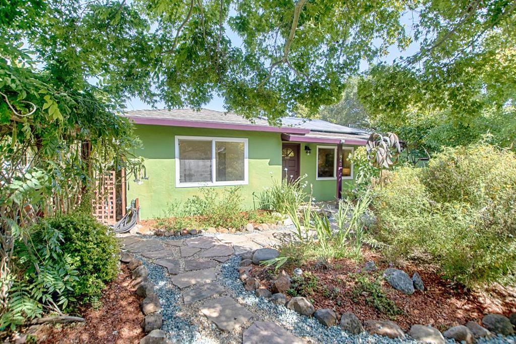 Come home to this charming private retreat! Close to beaches, restaurants and shopping this single level home is the perfect location. After a busy day at the beach come home to your own slice of paradise. Relax in the beautiful lushly landscaped yard with meandering paths and patio area. Lovingly maintained and updated, the home features skylights, dual pane windows, updated baths, newer flooring and fresh paint throughout. The large primary suite has a sitting area and access to the patio with a relaxing spa. A light filled artist studio in the back yard is a bonus! Come and see.