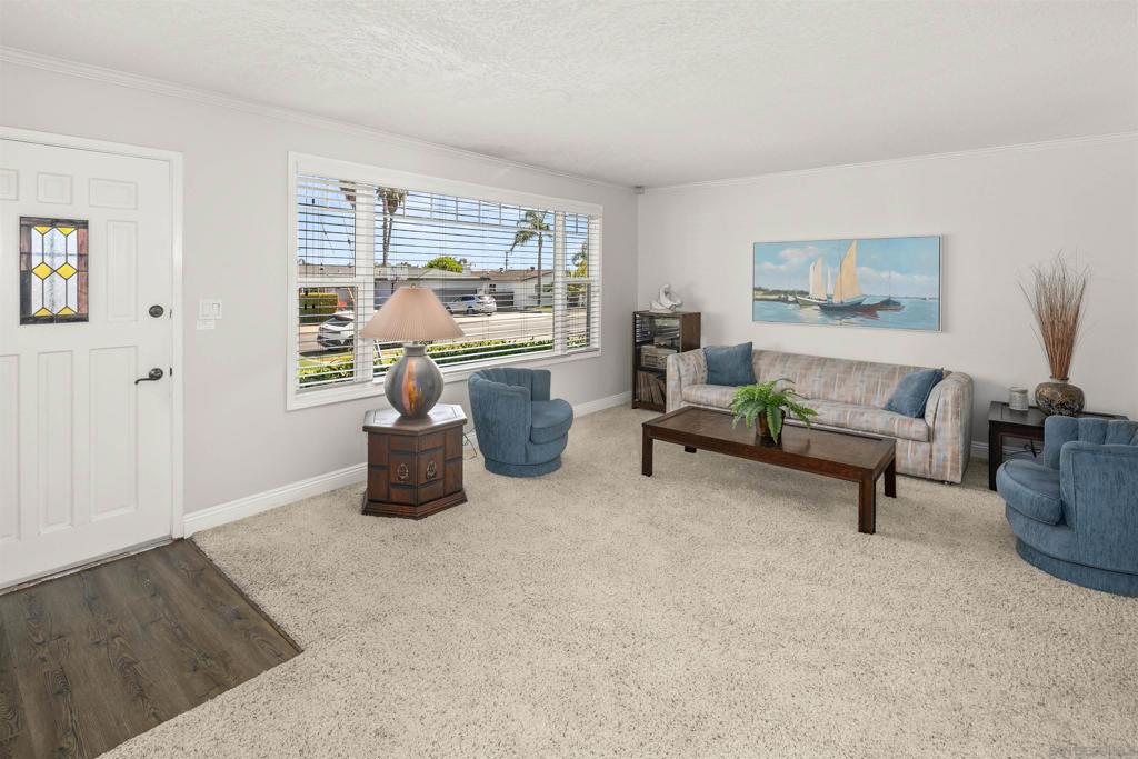 Centrally located, near to everything Clairemont has to offer! Large windows bring abundant light into the living and dining areas which are perfect for entertaining, while the step-down family room offers a more secluded gathering space. The exposed wood beam ceilings and fireplace add to the cozy atmosphere and a sliding glass door opens to a covered patio and backyard, creating a seamless indoor-outdoor flow. Two bedrooms and a full bathroom are located off the main living area, while the primary bedroom sits at the rear of the home. The primary includes an en-suite bathroom with direct access to the desirable, in-house laundry room. In addition to a wide driveway, this property boasts an attached 2-car garage ideal for more parking or storage. Move-in ready and close to top-rated schools, shopping, dining, and more, don’t miss out on this charming Clairemont home!