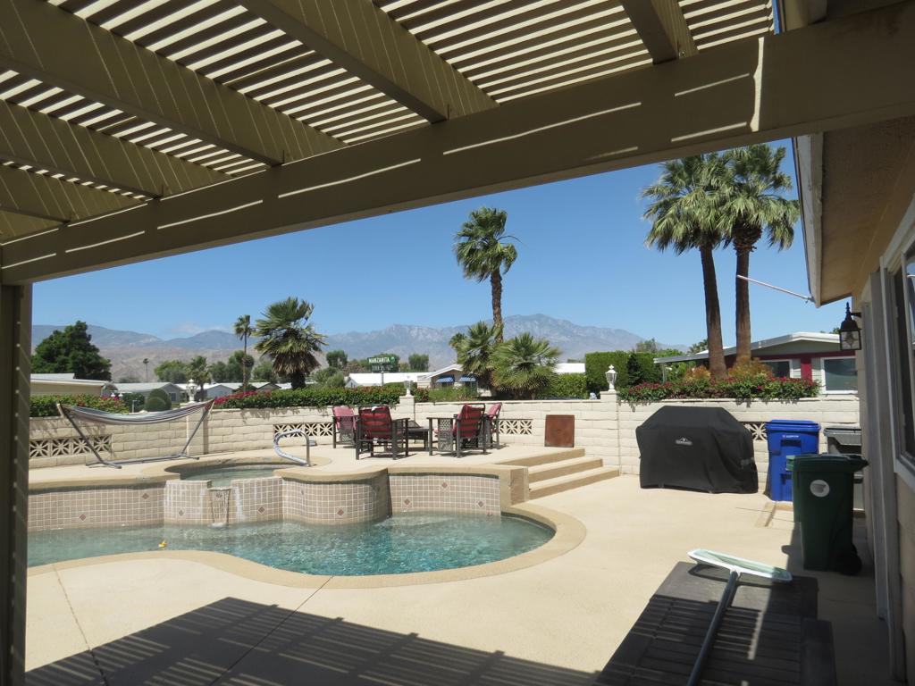Breathtaking panoramic Views on this private corner lot for your desert enjoyment. Gorgeous home with swimming pool, hot tub, and two car garage. Upgraded with new windows and plantation shutters, crown molding, ceramic tile floors with carpet in bedrooms. Both baths are updated as is the kitchen. The family room has a wet bar and an entertainment wall. Pool equipment and pool have been recently updated. Check out this one of a kind home with large walk-in closet in the main bedroom with a beautiful new tile shower. You will love the location and views!