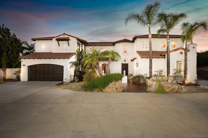 Set within the coveted Old Coach Collection, this stunning estate sits on one of the community’s largest lots—3.21 acres—with sweeping panoramic views. A tree-lined drive and fountain courtyard create a dramatic welcome, leading to a grand entry with soaring ceilings and light-filled living spaces. The main residence offers 4 bedrooms (plus 2 optional), 5.5 baths, a private office, bonus/exercise room, and upstairs loft. The chef’s kitchen impresses with Thermador appliances, quartz countertops, custom cabinetry, and a breakfast nook, flowing seamlessly into the spacious family room with fireplace and hardwood floors. Upstairs, the primary suite is a true retreat with its own fireplace, private balcony, and spa-inspired bath. Designed for entertaining, the backyard is a resort-style escape with pool and slide, spa, putting green, built-in BBQ, fire pit, and expansive lawn. A detached 320 sq. ft. casita adds versatility with its own bedroom, bath, kitchenette, sauna, and indoor/outdoor showers. Blending modern luxury with everyday comfort, this property offers an exceptional lifestyle in one of the area’s most sought-after enclaves.