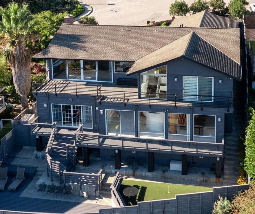 Unobstructed views of the Pacific Ocean and Monterey Bay from this exquisite home located in the desirable Westlake community. No expense was spared when completely remodeled in 1998. Tile, granite, marble and only the best in fixtures throughout. Main level of the home consists of the living room with fireplace, family room, dining area, kitchen, primary bedroom with bathroom, second bedroom, second bathroom and laundry room. An enchanting staircase leads downstairs to an additional living room with fireplace, bar area, third bedroom and bathroom. Large, expansive decks off both levels with spectacular views along with your own putting green. Too many features to list. See for yourself.