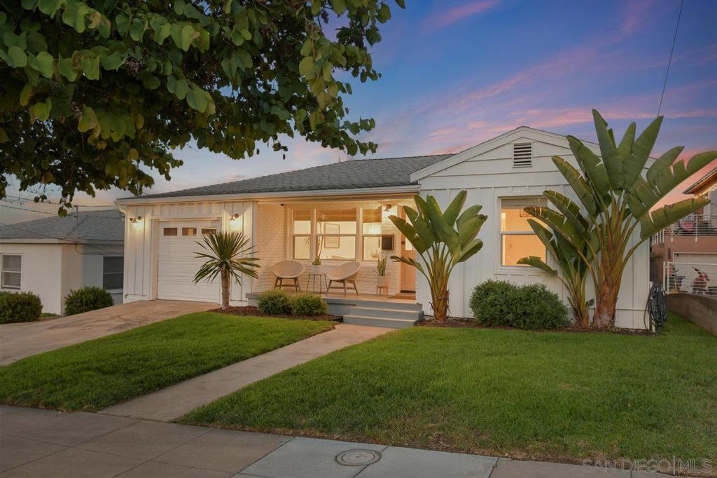 WOW! Perched high on the hillside in Point Loma Heights between the Ocean Beach village and Point Loma itself, this tastefully remodeled 3-bedroom, 2-bath single-level home showcases sweeping VIEWS of the downtown skyline and the surrounding hills. Bathed in natural light, the open-concept floor plan is enhanced by oak flooring, dual-paned windows, and central A/C! The heart of the home is the thoughtfully designed kitchen, complete with a viewpoint when working at the sink, and a cleverly concealed full-size washer and dryer tucked behind matching cabinetry. A bright dining area invites you in, while the spacious primary suite offers its own stunning views and a brick fireplace for cozy evenings. A stunning bonus room offers a lovely retreat with its floor-to-ceiling windows that frame the breathtaking panorama beyond. Outdoor living is equally impressive with its huge multi-use backyard w/ a beautiful xeriscape section with firepit, and another section that feels like a private orchard, boasting avocado, lemon, orange, mango trees, and rosemary & olive bushes, and lawn beyond. The bonus backyard studio/shed for yoga, work, or hobbies will delight you, and the whimsical chicken coop with its automatic door will warm your heart. You'll love the attached one-car garage for convenience, and an additional workshop that lies beneath the home. Just blocks from beloved neighborhood favorites such as Cesarina, Cotija’s, The Venetian, and Elvira’s, and with quick access to freeways, downtown, and the airport, this home offers the perfect blend of serenity, style, and convenience. **NOTE: Tax Assessor's Record shows 1,268 square feet, but with the Bonus Room (200sf; permits unknown), living space is 1,468sf.