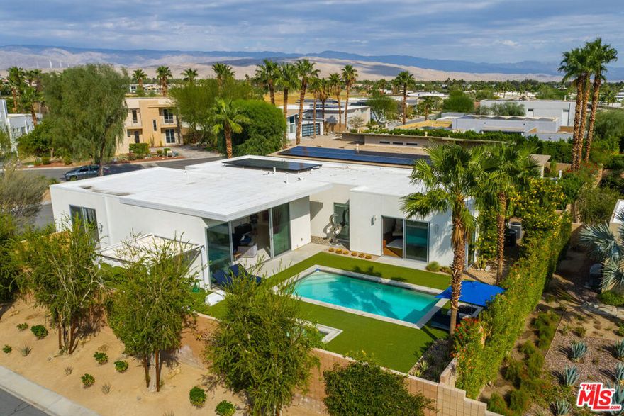 Welcome to "The Escena Marvel", a true jewel box home within the Escena community of Palm Springs. This stunning home showcases the award-winning "Garden/Gallery" Model by Alta Verde, celebrated with top honors from the National Association of Home Builders for its exquisite design and innovative architecture. This private modern oasis blends striking design with luxurious comfort, featuring an open-concept layout framed by walls of glass that offer breathtaking views of the San Jacinto Mountains. As you step inside, you'll discover a masterfully designed open-concept interior, where clean lines and abundant natural light set the tone for elevated desert living. Expansive Fleetwood sliding glass doors seamlessly merge indoor and outdoor spaces, while high ceilings and gallery-style walls provide the perfect backdrop for art and design. The minimalist kitchen is a true showpiece, featuring custom European cabinetry, a waterfall-edge island, and sleek, seamless finishes  perfectly balancing function and beauty. The great room exudes timeless elegance, gallery lighting perfect for grand entertaining or intimate evenings. In the primary suite enjoy a retreat-like atmosphere where oversized windows capture curated garden views and majestic Mountain views, and a spa-inspired bath that provides a sanctuary for relaxation. Additional guest rooms reflect the home's modern ethos  serene, flexible, and filled with natural light.The home features upgraded solar panels that are fully owned, significantly reducing your carbon footprint while maximizing savings. Outside, this jewel box home embraces a resort-inspired paradise. The architectural "L-shape" gracefully surrounds a sparkling pool and spa, complemented by meticulously landscaped desert gardens and tranquil lounging areas. Panoramic views of the San Jacinto Mountains provide a stunning backdrop, ensuring every sunset feels cinematic and every gathering memorable. Enhancing its allure, "The Escena Marvel" is equipped with cutting-edge smart home technology. Remotely control the garage door, sprinkler irrigation, thermostat, spa and pool lightings, as well as the landscape lights, ensuring convenience and a seamless, modern lifestyle.Living in Escena means enjoying one of Palm Springs' premier gated communities, complete with access to a championship golf course, a stylish clubhouse featuring dining at Escena Lounge & Grill, dog parks, biking trails, and beautifully maintained grounds. All of this is just minutes from downtown Palm Springs, the airport, and an array of entertainment and dining options.This property's bio communicates its luxurious amenities, modern design, and incredible lifestyle, along with sustainable living solutions. Whether looking to entertain or find a serene refuge, "The Escena Marvel" promises an unparalleled living experience in the heart of the desert.