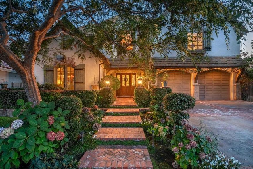 Nestled along the rolling fairways, this extraordinary residence combines timeless architecture with refined updates and sweeping golf course views. Behind its captivating, storybook façade lies a home of warmth, sophistication, and enduring quality.   The chef’s kitchen is as functional as it is beautiful, showcasing handmade pewter hardware on every knob and handle. The kitchen flows seamlessly into the welcoming family room and dining area, where walls of glass frame uninterrupted views of the course and greenery. Rich wood and stone flooring, vaulted beamed ceilings, and French doors infuse the interiors with a sense of rich elegance and warmth.   The expansive layout offers four ensuite bedrooms, a distinguished library, and a versatile office or sitting room. Thoughtful upgrades such as a whole-home water softening system, abundant attic storage, and an epoxy-finished three-car garage further underscore the home’s craftsmanship and attention to detail.  Life in Rancho Santa Fe is defined by prestige and privacy, where winding, tree-lined streets, equestrian trails, and world-class golf and tennis facilities create an unmatched sense of community. From the beloved Farmers Market and acclaimed local schools to Cars & Coffee in the Village and a charming array of dining options, the lifestyle offerings are as vibrant as they are refined—all just minutes from Del Mar’s pristine beaches and the excitement of the Del Mar Fairgrounds. Perfectly positioned between Green 5 and Tee 6, the home captures uninterrupted views and the essence of golf course living.