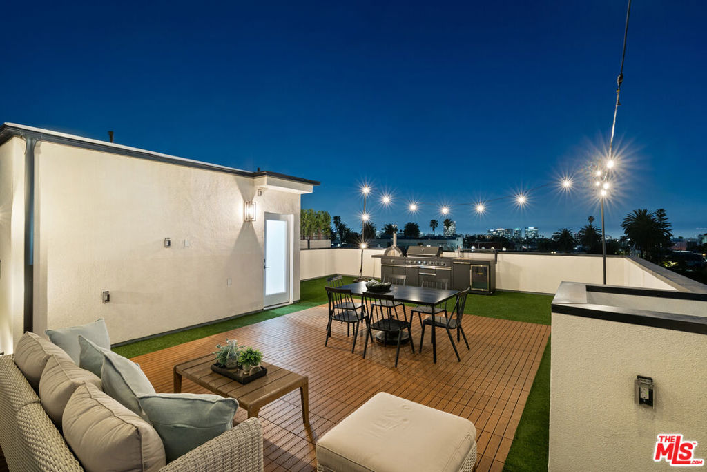 Welcome to The Heights at Serrano where Modern Luxury Meets Panoramic Bliss! Experience the pinnacle of sophisticated living in this brand-new single-family home, ideally situated on its own private lot. Boasting 4 spacious bedrooms, 4 elegant bathrooms and a side-by-side 2-car garage plus 2 uncovered parking spaces, this property is designed to elevate your lifestyle. Step inside to be greeted by soaring 10-foot ceilings, stylish shaker-style interior doors, and an abundance of natural light pouring in through oversized sliding glass doors that open to multiple serene balconies. The thoughtfully designed interiors offer a harmonious blend of space, light, and comfort. At the heart of the home lies a gourmet chef's kitchen, an absolute dream featuring a sprawling island, sleek custom cabinetry, and premium stainless steel appliances. With ample storage and a convenient washer and dryer, this home ensures effortless living for you and your family. The crown jewel is an expansive 779 sq. ft. rooftop terrace, offering breathtaking 360-degree views of iconic landmarks like the Hollywood Sign, Griffith Park Observatory, and the glittering Downtown skyline. This rooftop retreat is purpose-built for entertainment, featuring a fully-equipped outdoor kitchen (complete with a natural gas BBQ, fridge, and sink), composite decking, artificial turf, and charming string lighting perfect for hosting unforgettable gatherings or simply unwinding under the stars. For added tranquility and leisure, enjoy the privacy of a gated backyard, ideal for your furry friends, quiet relaxation, or lively weekend fun with family and friends. Nestled in the vibrant heart of Hollywood, this home offers unparalleled convenience with easy access to the 101 freeway, Hancock Park, and Paramount Studios, among other attractions. With four new, exquisitely built single-family homes now available at The Heights at Serrano, this is your opportunity to own a piece of modern Hollywood luxury. The residence has NO HOA and NO COMMON WALLS between each home. Seller can help with your financing by buying down your interest rate, call for details. Please reach out today for more information about 540 , 540 1/2 and 542 1/2 N. Serrano Avenue and to schedule a private tour!
