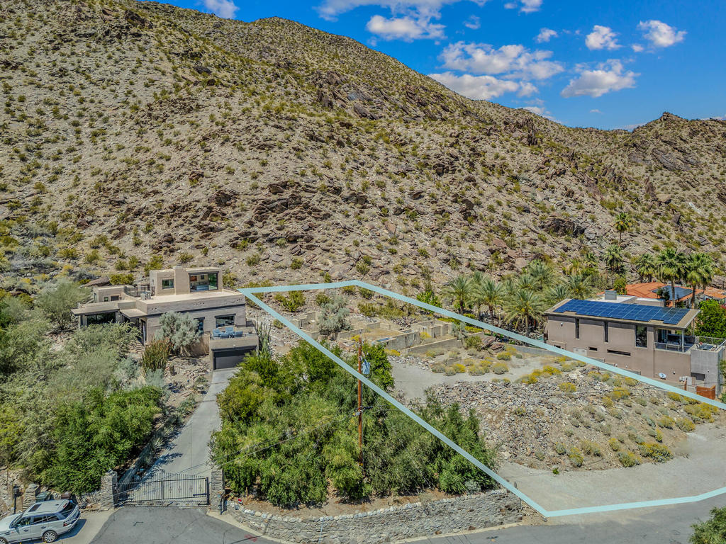 With the most impressive hillside boulder formations and breathtaking Valley views, this is truly a rare opportunity to secure currently one of the highest and most secluded hillside lot available in the highly desirable neighborhood of The Mesa, in South Palm Springs. Perfectly poised to frame enchanting views that stretch across a sea of palm trees and dramatic hills, this lot (Fee land, you own the land) is sold with the architectural plans approved by the City's ARC, and engineering studies that will save a buyer invaluable time and capital. The architectural plans are the creation of one the most prestigious Architectural firms, recipient of nearly 200 regional and national awards, including the 2023 Architizer A+ Jury Award for Best Residential Firm. Their work has also been widely featured in national and international publications. Alternatively you could purchase this land to expand the already exceptionally reinterpreted and fully remodeled historic home adjacent to this parcel, which is also for sale (MLS#219110331), and once the desert getaway for renowned author Zane Grey. Utilities conveniently located at the street.