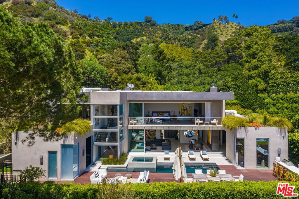 Enter 1709 Rising Glen: A modern estate set in the hills just above Sunset Plaza & the world famous Sunset Strip, minutes from the best shopping, dining & entertainment that LA has to offer. Enter a private & gated driveway to oversized motor court w/room for 10 cars & two-car garage. Step through the front door to a large open concept floor plan living & dining room w/honed limestone floors & Fleetwood glass sliders that open to the pool & entertainment deck. This is quintessential Southern California indoor/outdoor living at its finest. A sleek & modern, gourmet chef's kitchen includes top of the line appliances & adjoining lounge area. A modern floating staircase leads to the second story luxury master suite w/city and canyon views & includes a massive walk in closet, oversized bathroom, 2 private balconies & gym. Lower level includes 4 additional guest suites, a recording studio & large grassy yard/dog run. Experience the pinnacle of style & design and live among the stars.