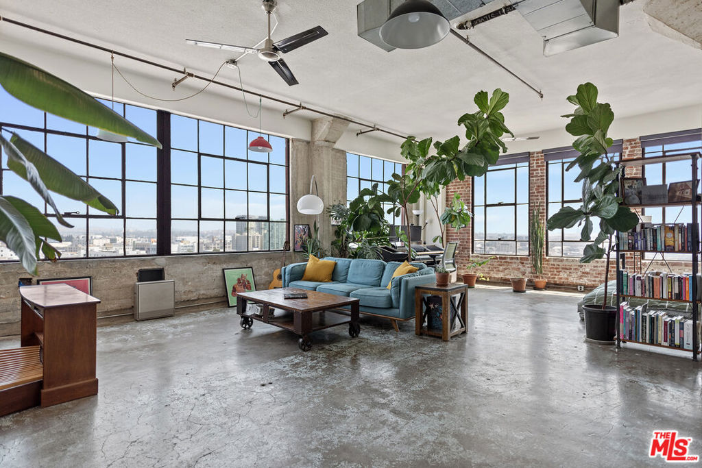 Discover Unit 1106 at the historic Textile Building Lofts, where classic 1920s architecture meets modern urban living with the added benefit of the prestigious Mills Act designation, offering significant property tax savings. This freshly painted 890 sq. ft. corner loft has been thoughtfully updated while preserving its historic character. Restored exposed brick walls, 12-foot ceilings, and polished concrete floors create a striking industrial aesthetic, while expansive north-facing windows provide wide city views that stretch to the mountains, filling the space with natural light. The open layout includes a spacious Loft living area, a modern kitchen with stainless steel appliances, Full bathroom with a tub and the convenience of an in-unit washer and dryer with extra storage. Adding to its rarity, the unit comes with secure underground parking inside the building a coveted feature in a Downtown Los Angeles historic Building. As part of the Textile Building community, residents enjoy access to a rooftop pool and spa, a fully equipped fitness center, Basketball Court and the unique experience of living in a 1926 Gothic Revival landmark converted into lofts in 2005. Located in the heart of the Fashion District, you'll be just steps from acclaimed restaurants, boutique shops, nightlife, and minutes to LA Live, the Arts District, and Metro transit. Unit 1106 combines historic charm, mountain views, rare underground parking, and substantial Mills Act tax savings. An extraordinary opportunity in Downtown LA.