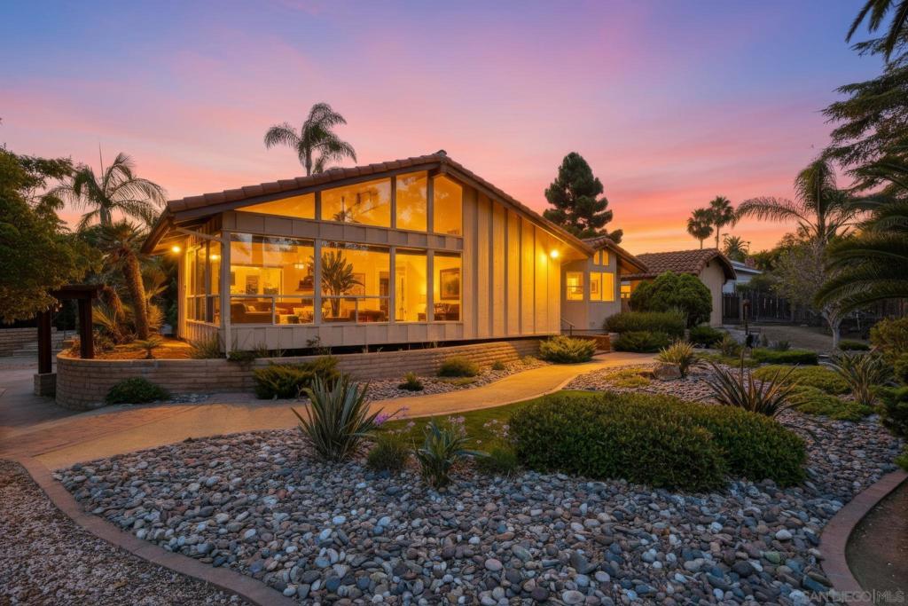 Perched at the top of a hill, at the end of a quiet cul-de-sac, this Fire Mountain dream property is a rare find! This home offers nearly half an acre of beautifully landscaped, hilltop living with sweeping 180° views, including distant ocean and breathtaking sunsets. You can really see the pride of ownership in this home. You'll find updated Milgard windows, a new HVAC system, an attic fan, updated roof, ongoing termite control, and a clean wood structure. This makes it the perfect home for someone looking to do a cosmetic remodel. The two-car garage is complemented by two separate storage or workshop spaces, and for those looking for something truly unique, the property includes a full-size bunker built in the '70s, perfect for a wine cellar, extra storage, or a creative hideaway. The lush landscaping is anchored by towering Canary Palms, creating a serene and private outdoor setting. This is a rare opportunity to own a single-level home with incredible space, stunning views, and tons of character in one of Oceanside's most desirable neighborhoods.