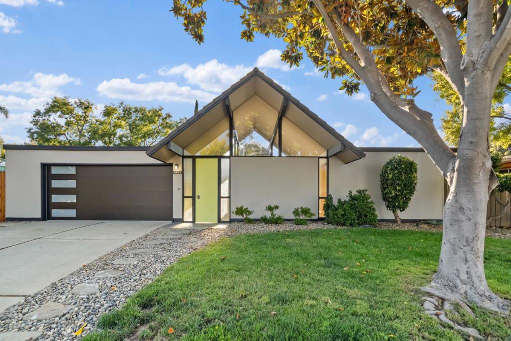 This double gable atrium (or double A-frame) is arguably Eichler's most iconic and popular model, consisting of two mirrored rooflines with dramatic ceiling heights flanking an open air atrium. Built in 1970, and designed by Claude Oakland, this Eichler embodies mid century modern living to its fullest with a larger footprint and lot size, globe lighting, T&G stained redwood ceilings, floor-to-ceiling panels of glass, tile flooring and radiant heating. Enter into the light filled open concept living and dining space with quintessential brick fireplace and views into the backyard. Enthusiasts will appreciate the meticulously maintained original kitchen cabinets and formica countertops, peninsula seating, walk-in pantry and family sitting area, with slider into the side patio. Additionally there is a spacious laundry/utility room off the kitchen. The primary suite has an updated bath, walk-in closet and slider to the backyard. Enjoy the beautifully landscaped yards with pergola, lawn, and wrap around concrete patio. Located in Sunnyvales coveted Serra Park neighborhood with top rated schools: West Valley Elem, Cupertino Middle, Homestead High. Just 4 miles to Apple Campus & Main St Cupertino, and close to downtown SV shops, restaurants, Farmers Market and CalTrain station