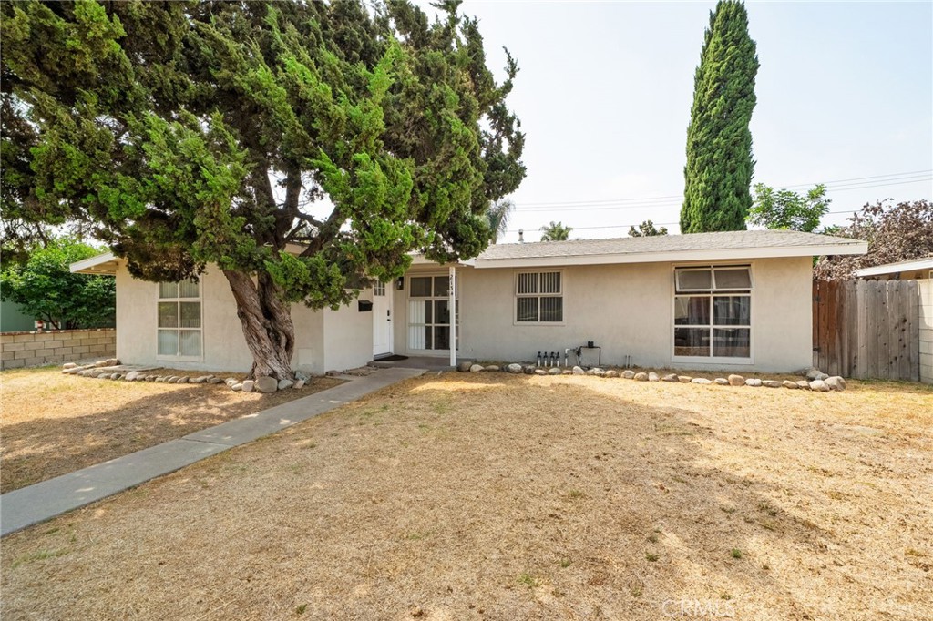 Situated on a generous 6,300 sq. ft. lot, this beautifully maintained 4-bedroom, 2-bathroom home offers both comfort and style. The remodeled kitchen features modern finishes, ample cabinetry, and sleek countertops, making it the perfect space for cooking and gathering. Sunlight pours through large windows, filling the home with warm, natural light and highlighting the laminate wood floors that flow throughout the main living areas. With spacious bedrooms, updated bathrooms, and a backyard ready for outdoor living or entertaining, this home blends functionality with inviting charm.
