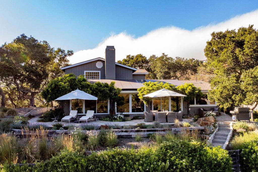 This 4-bedroom, 3.5-bath almost 3200 square foot home offers the perfect blend of desirable location and ultimate privacy. Situated at the end of a secluded cul-de-sac and just west of Carmel Valley Village's charming restaurants and shops, this property is a rare find. Adding to its appeal this home is located within the highly sought-after Carmel Unified School District. Enjoy stunning views from nearly every room. East and west panoramic views offer both sunrises and sunsets. The layout includes two spacious bedrooms on the main level and two additional bedrooms upstairs. A cook's kitchen features an expansive island, beautiful stone countertops, and abundant storage, along with a cozy eat-in area. A separate, formal dining area is located just off the living room, and a fireplace in the family room creates a warm and inviting atmosphere. The house is equipped with solar panels; and the property is located in the Water West District offering a potential for a future pool. Outside, there are several gathering areas with beautiful stone patios and professionally landscaped gardens creating a private outdoor sanctuary. Majestic, statuesque oak trees lend a sense of timeless tranquility, making this the perfect place to relax and unwind.