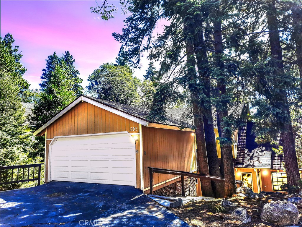 Discover your mountain sanctuary in this spacious and inviting home on a quiet street with Lake Rights! Beautiful forest views and a large, treed lot make the perfect retreat. Step into the entry with a stunning Stained-Glass window that brings ethereal light into the home. The wood Cathedral Ceiling in the Living Room above the massive brick fireplace is the essence of mountain ambiance. On the main floor is everything you need – a spacious private Primary Bedroom with an en-suite bath, walk-in closet and beautiful forest views, Living Room and Dining Room with beautiful views, a Kitchen opening up to the living area, a Laundry and Powder Room. The large windows bring in natures’ best with views of towering pines and vibrant oaks. The large Deck outside the Dining Room offers plenty of space for the whole gang for Al Fresco dining, listening to the birds, the whispering of the pines or watching the wildlife. Upstairs are three spacious Bedrooms with vaulted wood ceilings and a full Bath for your guests. Downstairs is another Bedroom, another full Bath and a great Game Room with River Rock Fireplace, Bar, Pool/Ping Pong Table and Basketball Shot game! Right off the Game Room is a large, covered deck for relaxation, quiet conversation and convenient access to the dog run below. There is level entry into the two-car garage and level parking off a paved and maintained road that is plowed by the County. Just a few landscape stairs to the front door, this turn-key furnished home is move-in ready! Easy commute down the hill. Enjoy all the mountain has to offer and make your Lake Arrowhead Dream a reality! The exterior of the home needs to be painted which is reflected in the sales price.