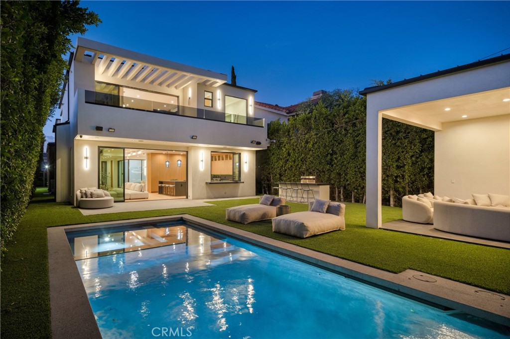 Welcome to 14822 Hesby St, where PRIVACY, vision, precision and elegance converge. A striking newer construction estate that blends modern design with luxury. This state-of-the-art smart home showcases a dramatic glass staircase, soaring high ceilings, and expansive glass pocket doors that open to a seamless indoor-outdoor experience. The chef’s kitchen is a showpiece, featuring dual oversized islands, a sleek breakfast bar, and inspiring white oak floors throughout. Retreat to the primary suite with its spa inspired bath, spacious walk-in closet, and two private balconies with sitting area and fireplace. Outside, a resort-style pool, spa, and cabana create the ultimate setting for relaxation and entertaining. Built by MLR Development one of Los Angeles’s most reputable builders, this residence is a sanctuary of abundance designed for seamless living and timeless beauty.