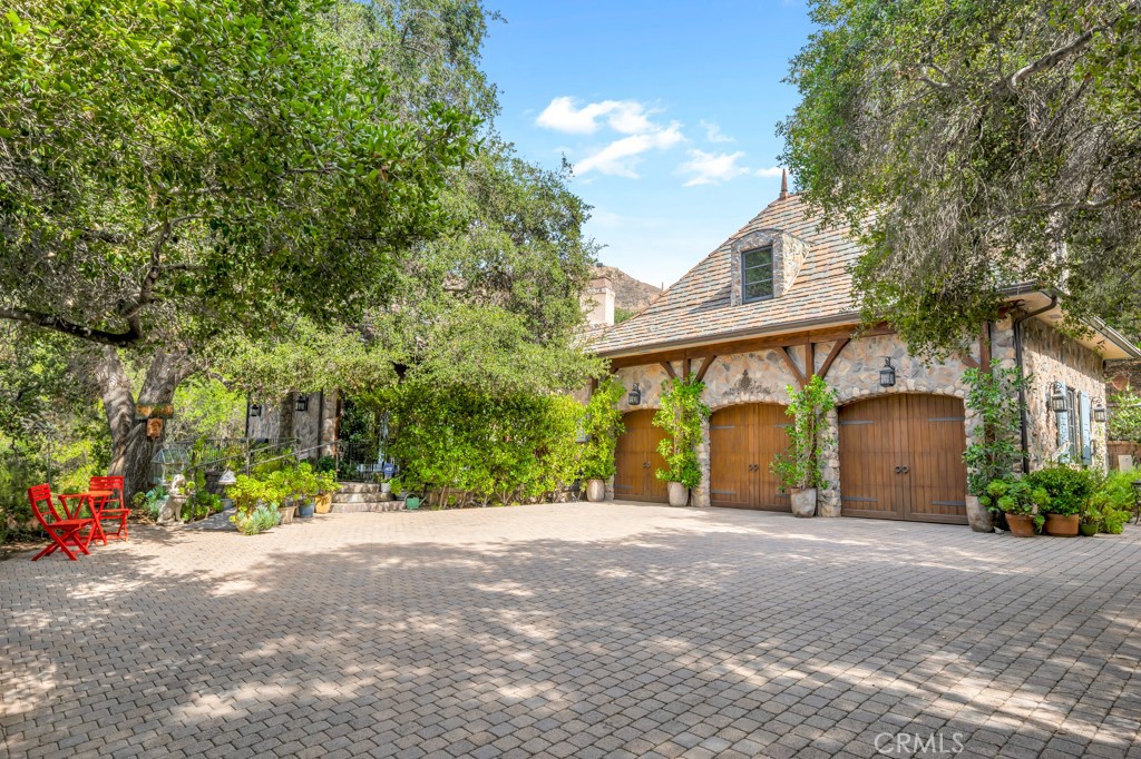 Step into a world of timeless elegance where nature and architecture meet in perfect harmony. Just minutes from Calabasas, Viewpoint School, and The Commons, this extraordinary custom estate offers the rare opportunity to live in a castle-like sanctuary surrounded by nearly 1.5 acres of enchanting oak trees.
A meandering manmade creek flows through the property, creating a serene backdrop for multiple outdoor living spaces designed for both intimate evenings and grand gatherings. Every detail of this 3,000 sq. ft. residence, reflects artistry and craftsmanship—its stone exterior evokes the romance of old-world European estates, while its interiors blend warmth, sophistication, and comfort.
Inside, discover 3 luxurious bedrooms, 4 bathrooms, a stately office with private entrance, a mud room, formal dining room, and an inviting family room that opens to the gourmet kitchen. Natural light floods the home, highlighting its timeless finishes and the seamless connection to the outdoors.
More than a home, this is a private retreat—a place where elegance, serenity, and exclusivity create an unparalleled lifestyle in the heart of Topanga.