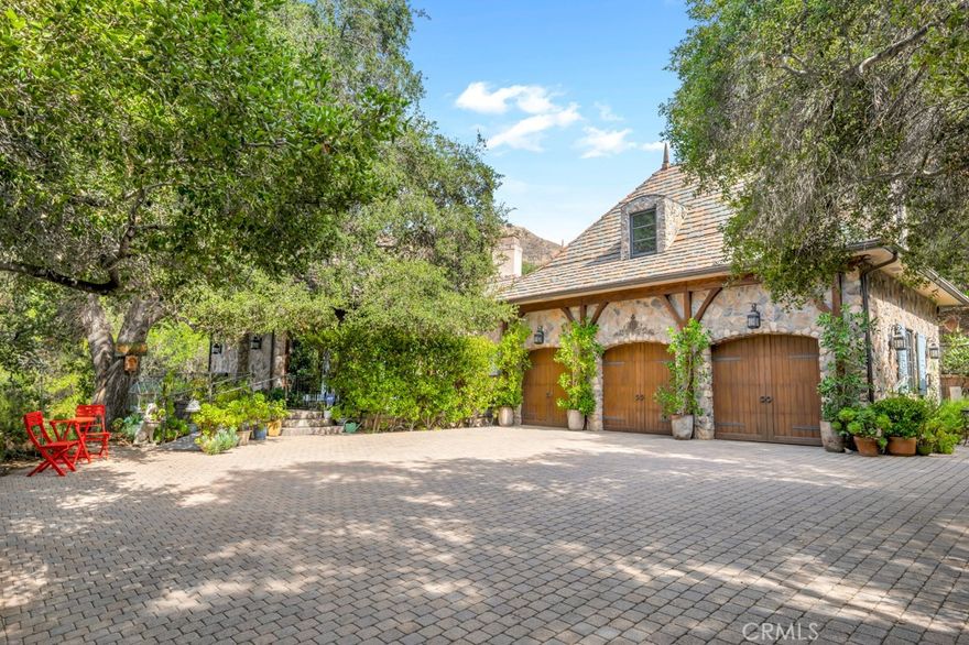 Step into a world of timeless elegance where nature and architecture meet in perfect harmony. Just minutes from Calabasas, Viewpoint School, and The Commons, this extraordinary custom estate offers the rare opportunity to live in a castle-like sanctuary surrounded by nearly 1.5 acres of enchanting oak trees.
A meandering manmade creek flows through the property, creating a serene backdrop for multiple outdoor living spaces designed for both intimate evenings and grand gatherings. Every detail of this 3,000 sq. ft. residence, reflects artistry and craftsmanship—its stone exterior evokes the romance of old-world European estates, while its interiors blend warmth, sophistication, and comfort.
Inside, discover 3 luxurious bedrooms, 4 bathrooms, a stately office with private entrance, a mud room, formal dining room, and an inviting family room that opens to the gourmet kitchen. Natural light floods the home, highlighting its timeless finishes and the seamless connection to the outdoors.
More than a home, this is a private retreat—a place where elegance, serenity, and exclusivity create an unparalleled lifestyle in the heart of Topanga.