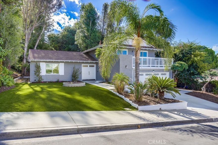 Welcome to this beautifully remodeled home sitting on a huge lot with a view, this property is the perfect blend of modern design, comfort, privacy and location. Offering a master suite upstairs and a bonus suite creating an additional master retreat downstairs, 3 full baths on an expansive 1/4 acre lot with stunning views. Thoughtfully reimagined inside and out, this residence blends modern upgrades with timeless style. The heart of the home features a luxuriously appointed kitchen with quartz countertops, waterfall edge, new beautifully designed cabinetry with highly appointed hardware, stainless steel appliances including a wine refrigerator, lighting, windows, sink and faucet. Throughout the home, white oak luxury vinyl plank flooring (LVP) creates a durable yet stylish flow. Redesigned bathrooms with new vanities, fixtures, and custom showers. A downstairs bonus suite provides a private retreat, perfect as a second master or private guest space. The interior walls and ceilings are complemented by soft smooth finishes, and a full interior repaint in Swiss Coffee and white for a bright, move-in ready atmosphere. New windows enhance natural light and improved style and efficiency, while a brand-new AC system ensures comfort. Curb appeal shines with a full exterior repaint and refreshed trim, paired with updated ultra low maintenance landscaping and hardscape to maximize outdoor enjoyment.