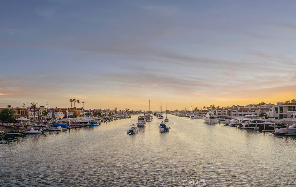 Welcome to 994 Bayside Cove, a rare offering in one of Newport Beach’s most sought-after gated communities. This designer-upgraded end-unit townhome combines upscale coastal living with everyday convenience, just steps from the bayfront and charming Balboa Island.
Spanning 1,515 square feet, this 2-bedroom, 2.5-bath residence offers an open-concept main level featuring a bright living and dining space, mahogany double doors leading to a private grassy patio, and a chef’s kitchen with granite countertops and premium stainless steel appliances.
Upstairs, both bedrooms boast soaring ceilings, generous closet space, and private balconies that invite in cool ocean breezes. The primary suite features a spa-inspired bath with a soaking tub and elegant travertine finishes, creating a serene retreat.
Enjoy resort-style amenities including a newly remodeled community pool, private sandy beach, and dock access just steps away. Whether you're walking to Balboa Island’s iconic shops and restaurants, hopping on the ferry, or simply taking in the luxury yachts lining the bay, every day here feels like a vacation.
Additional features include a two-car garage, extra storage, and convenient access to the 55, 73, and Pacific Coast Highway. With homes in Bayside Cove rarely available, this is your chance to own a slice of Newport Beach paradise.