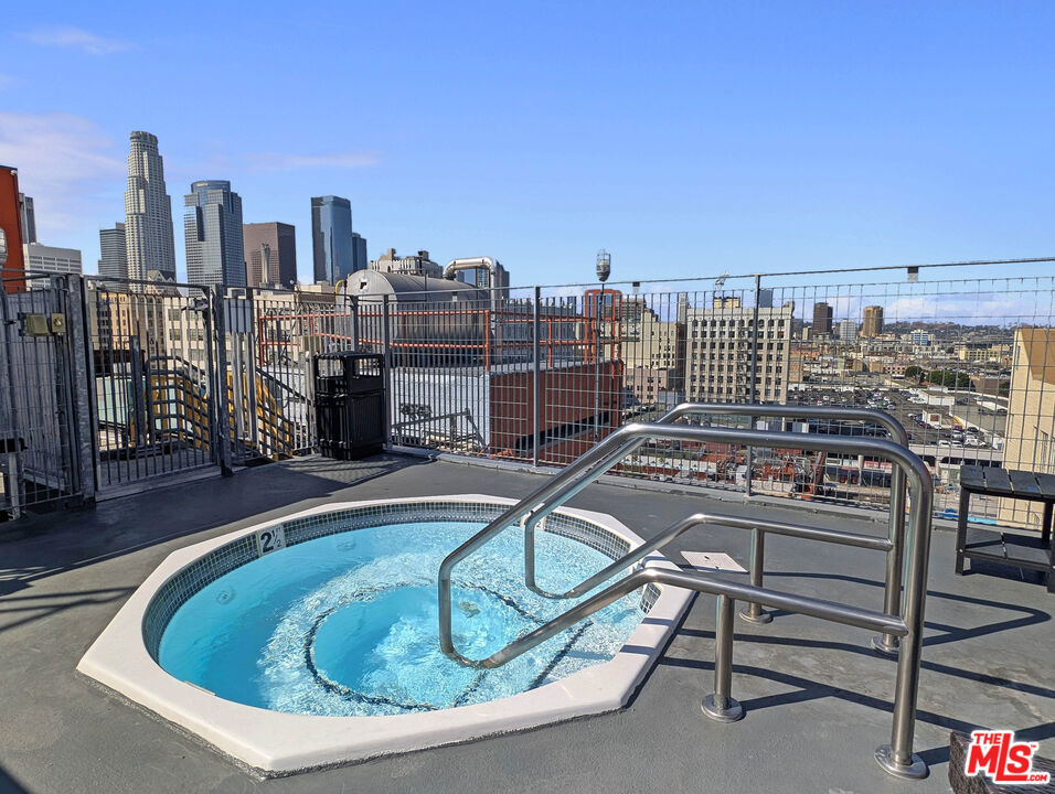 Join the Penthouse Club: Iconic DTLA Loft with STR Approval + Mills Act Tax Benefits! Heated rooftop pool, Three hot tubs, Golf cage, Basketball court, Market, Food court, Private shuttle, Full gym, 24-hour staff - all in a historic luxury community under $500K. Welcome to your private club in the sky. Perched in the Eckardt Building at Santee Village, a 1914 Historic-Cultural Landmark converted to lofts in 2007, this rare penthouse in DTLA's Fashion District blends vintage character with elevated living. Currently licensed for short-term rental use and benefiting from Mills Act property tax savings, it's a standout for investors, international buyers, and those seeking a pied-a-terre, flexible-use residence or stylish long-term rental. The approx. 860 sqft unit features ceilings estimated at 14 feet, a frosted skylight, exposed concrete and beams, built-in electric fireplace, smart-access electronic lock, and a Nest-compatible thermostat (included, wired for but not installed). Upgrades include a French-door refrigerator, designer lighting, and sliding space-saving closet doors. Optional furnishings available. An exceptional alternative to renting offering lock-and-leave convenience, elevated design, and a foothold in one of DTLA's fastest-developing neighborhoods. Santee Village offers a rare amenity-rich environment: heated rooftop pool, multiple hot tubs (including a spa deck exclusive to Eckardt/Cornell owners), basketball court, golf cage, fitness center, BBQ lounges, lounge decks, on-site Santee Market and food court, package/key storage, pet-friendly policies, on-site management and handyman services, guest parking and off-site parking space with evening shuttle. HOA dues cover most utilities (excluding electricity). Enjoy local favorites all within a few blocks: Holy Basil, Poppy & Rose, Zinque, Civil Coffee, Alma at the Grove, Whole Foods, Ralphs, and Jalsah Yemeni Coffee. With a Walk Score of 98, this location offers seamless access to Downtown LA's most vibrant dining, retail, and transit options. All information deemed reliable but not guaranteed. Buyer to verify square footage, tax programs, furnishings, amenities, parking, and HOA terms. Broker and agent make no warranties and shall be held harmless. Buyer to verify transferability, reapplication requirements, and HOA policy enforcement.