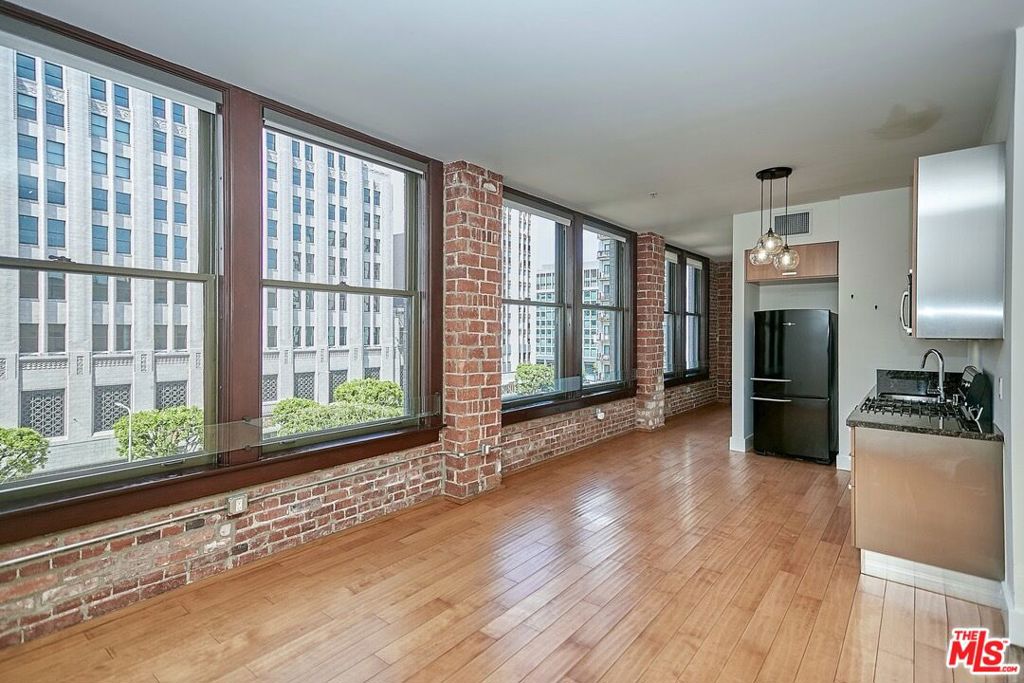 Rarely available is this beautiful corner unit overlooking the Spring Street park in the historic Rowan Lofts. Brilliant sunlight fills this home from a wall full of wide double hung mahogany windows that highlights the original brickwork from 1912. Enjoy the Downtown skyline from the spacious living room or the comfort of the secluded bedroom tucked in the back corner. Featuring an updated kitchen with stainless appliances and granite countertops, hardwood floors throughout, and a vast bathroom with ample space, this home encompasses the genuine essence of Downtown living. Keeping true to the original beaux-arts decor, Rowan is clad in original brick and terra cotta facade, while vast hallways are adorned with Carrera marble with original copper and brass staircase banisters. Amenities include a lush outdoor garden, BBQ grill stations, hot & cold plunge pools, resident lounge, available on-site storage, and 24-hr security & concierge. Parking is not included, however spaces are available for residents if desired (additional fee). Please call regarding pets. Tenant responsible for electric, internet, cable tv, and HOA move in/out fees.