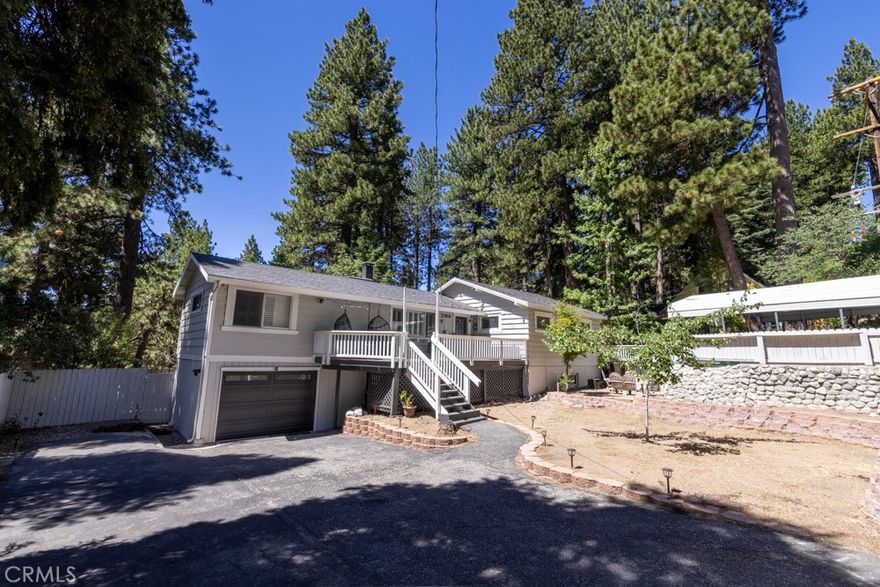 A prime piece of Running Springs real estate in San Bernardino County. This 3-bedroom, 3-bathroom single-family residence offers 2,218 square feet of updated living space on a 6,400 square foot lot. Great for families, outdoor lovers, or investors, it combines rustic charm with modern amenities for comfortable mountain living.

Enter through the convenient mud room, a must for snowy days, into an open main floor featuring a renovated kitchen, stainless steel Samsung appliances, custom shaker cabinets, and a breakfast bar great for casual meals. The adjacent dining area flows seamlessly into the living room, highlighted by a wood-burning fireplace and large windows showcasing tree-lined views. The primary bedroom suite includes a walk-in closet and a separate bath with dual vanities, while a second bedroom and a full bath complete this level.

Downstairs, the versatile lower area has been reimagined as a gym and entertainment space, boasting a dedicated workout zone with room for equipment, a game room for billiards or gaming, and a spacious family room with another fireplace for movie nights or gatherings. A third bedroom, additional bath, and laundry room add functionality, with potential to create a separate in-law suite.

Recent upgrades elevate this home: newly installed central air conditioning ensures cool summers, an electric vehicle charger station in the 2-car garage supports green living, energy-efficient LED lighting, fresh interior paint, and updated bathrooms. Outside, the fully fenced yard provides privacy, a deck for barbecues, ample parking for RVs, boats, or multiple vehicles, and easy access to a detached carport. Priced competitively, this turnkey mountain retreat is ready for new owners. Don't miss out on this updated property with a renovated kitchen, home gym, entertainment area, EV charging, A/C, and more. Contact for a showing today!