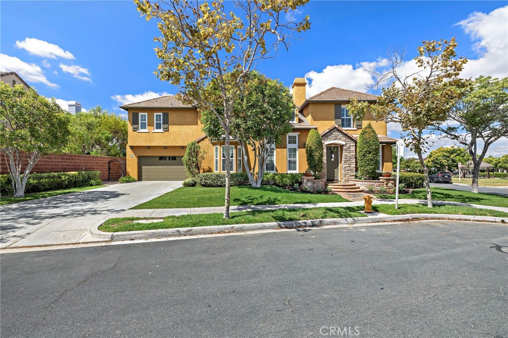 Welcome to 63 Tuberose—a stunning Canopy Lane Plan 4 home located in one of Ladera Ranch’s most sought-after enclaves, just steps from Poets Park, Oso Grande Elementary, and Founders Park. This beautiful corner-lot residence offers timeless curb appeal, expansive indoor-outdoor living, and a thoughtfully designed open floorplan filled with natural light. Step inside to soaring high ceilings, tile flooring, and a truly open layout. The spacious kitchen features white cabinetry, a large center island, and a new dishwasher, making it ideal for entertaining. The adjacent great room and dining area flow seamlessly, while plantation shutters and updated LED recessed lighting add warmth and elegance. A full bedroom and full bathroom on the main level is perfect for guests or multi-generational living. Upstairs you’ll find a generous loft—ideal for a media room, office, or playroom—that overlooks the open space below, enhancing the airy feel of the home. The primary suite is a true retreat, complete with a sitting area, large walk-in closet, soaking tub, separate shower, and dual vanities. Two additional bedrooms, a full bath, and an upstairs laundry room complete the second floor. Enjoy privacy and tranquility in your large yard, finished with updated hardscape, rock features, and newer landscaping. Relax while overlooking Poets Park or entertain with ease on this expansive lot. The 3-car garage with epoxy flooring, extended driveway, newer water heater, and other thoughtful updates complete the package. Ladera Ranch is renowned for its resort-style amenities including a remodeled water park, hiking and biking trails, clubhouses, pools, and top-rated schools. Don’t miss your opportunity to live in one of South Orange County’s most vibrant and connected communities.
