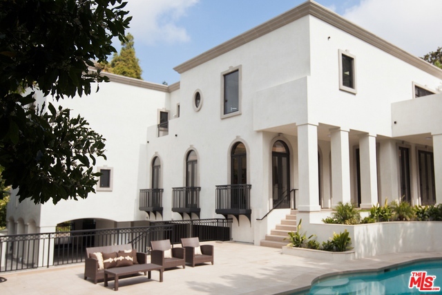 Motivated Seller! Glamorous and chic, this contemporary Spanish will impress the most discriminating buyer. A grand, two story entry with sculptural, free floating, staircase, welcomes you to a warm, light filled home. Expansive, open floor plan with outstanding volume. Library - media room with alligator etched, black granite wall. Mirrored, old world stone fireplaces. An interior courtyard fountain creates a tranquil and serene ambiance. Quiet, private back yard with a salt water pool and spa. Wonderful, outdoor patio is ideal for entertaining... both for intimate gatherings or large scale events. Chef's kitchen designed to inspire. Gracious, master wing with spa bath and luxurious, round, soaking tub. Views across the canyon. Dual closets - dual water closets. Four additional, en-suite guest rooms. Large, gated motor court with garaged parking for three cars. Elevator from garage to all upper floors. Separate maids quarters. Completed in 2013 with meticulous attention to detail.
