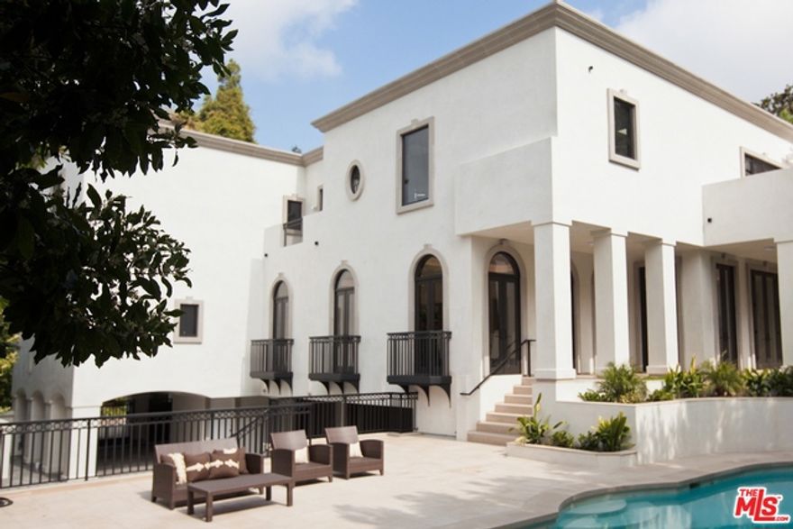 Motivated Seller! Glamorous and chic, this contemporary Spanish will impress the most discriminating buyer. A grand, two story entry with sculptural, free floating, staircase, welcomes you to a warm, light filled home. Expansive, open floor plan with outstanding volume. Library - media room with alligator etched, black granite wall. Mirrored, old world stone fireplaces. An interior courtyard fountain creates a tranquil and serene ambiance. Quiet, private back yard with a salt water pool and spa. Wonderful, outdoor patio is ideal for entertaining... both for intimate gatherings or large scale events. Chef's kitchen designed to inspire. Gracious, master wing with spa bath and luxurious, round, soaking tub. Views across the canyon. Dual closets - dual water closets. Four additional, en-suite guest rooms. Large, gated motor court with garaged parking for three cars. Elevator from garage to all upper floors. Separate maids quarters. Completed in 2013 with meticulous attention to detail.